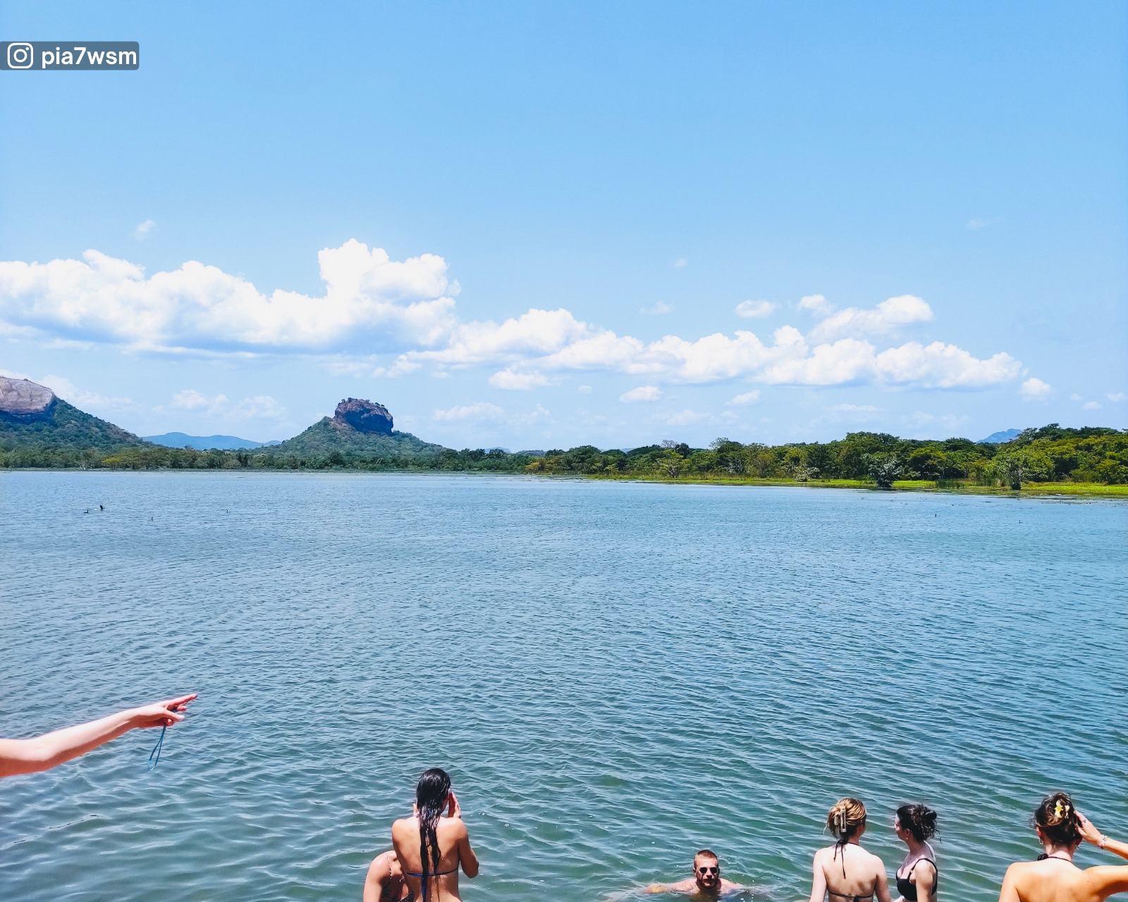 A dip in Thalkote Lake with views of Pidurangala Rock and Sigiriya Rock