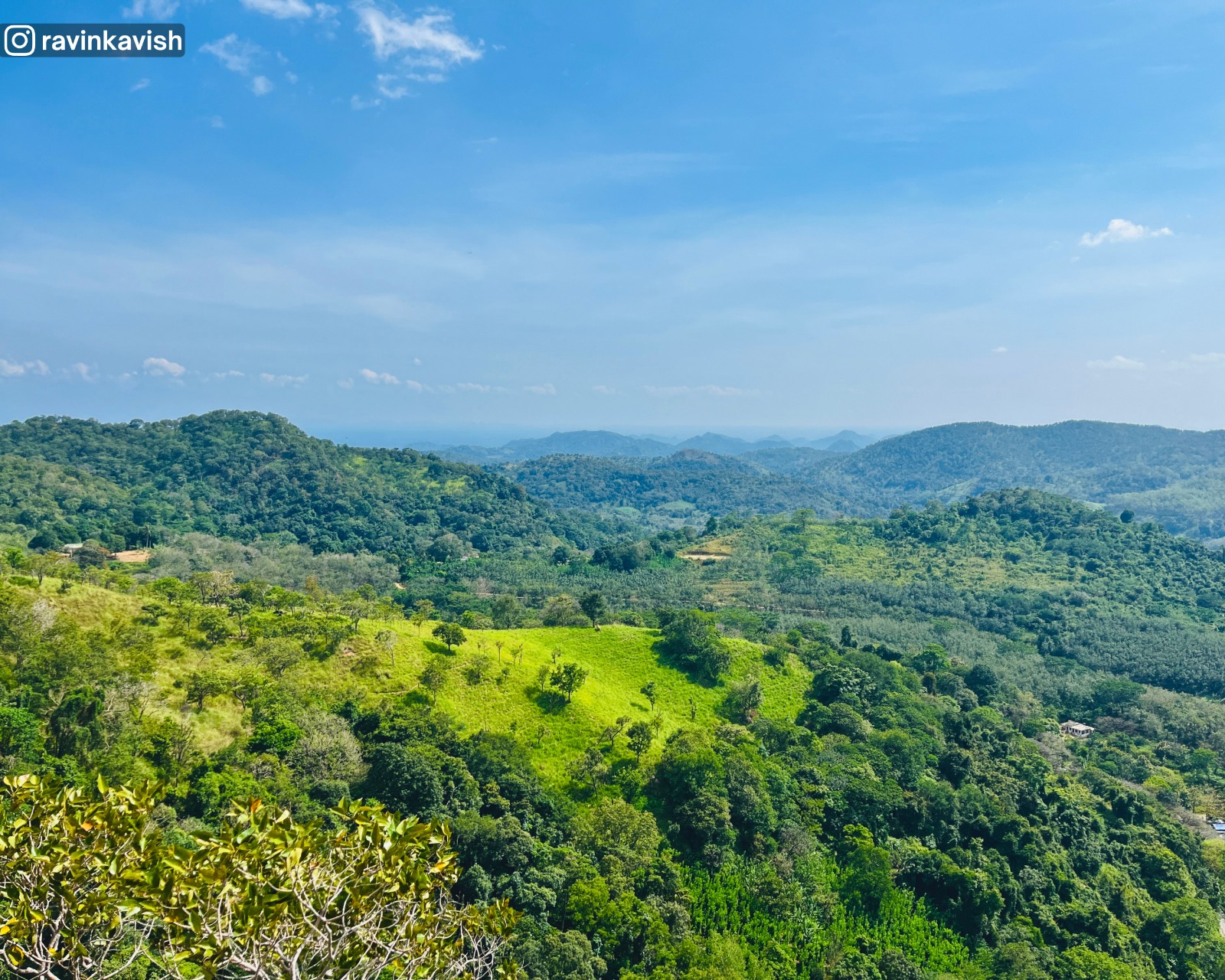 A lone elephant appears as a tiny dot in the vast open grasslands viewed from the top of Diyaluma Falls final drop showcasing Sri Lankas natural beauty and wildlife