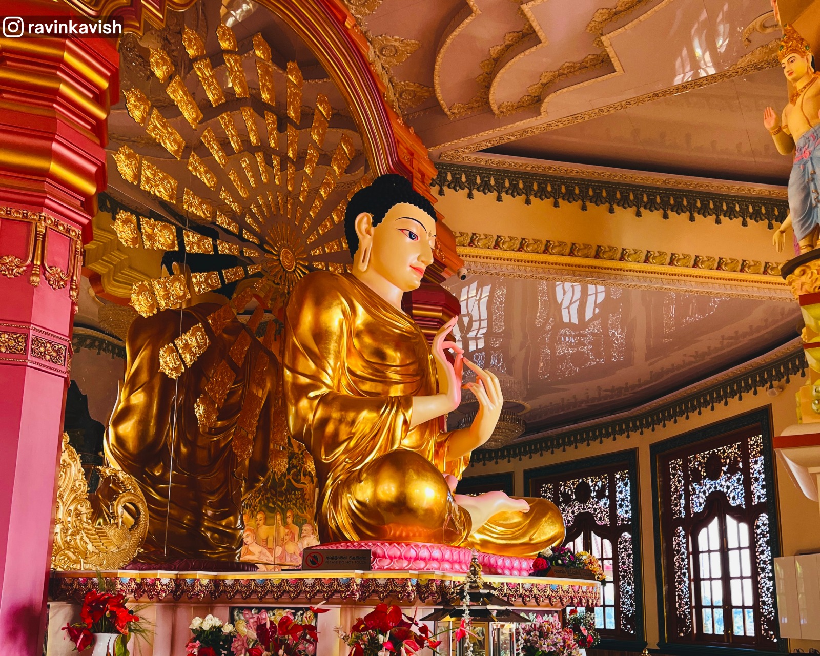 A vibrant seated Buddha statue, housed inside the stupa of Mahamuwana Monastery, Kumbalwela near Ella