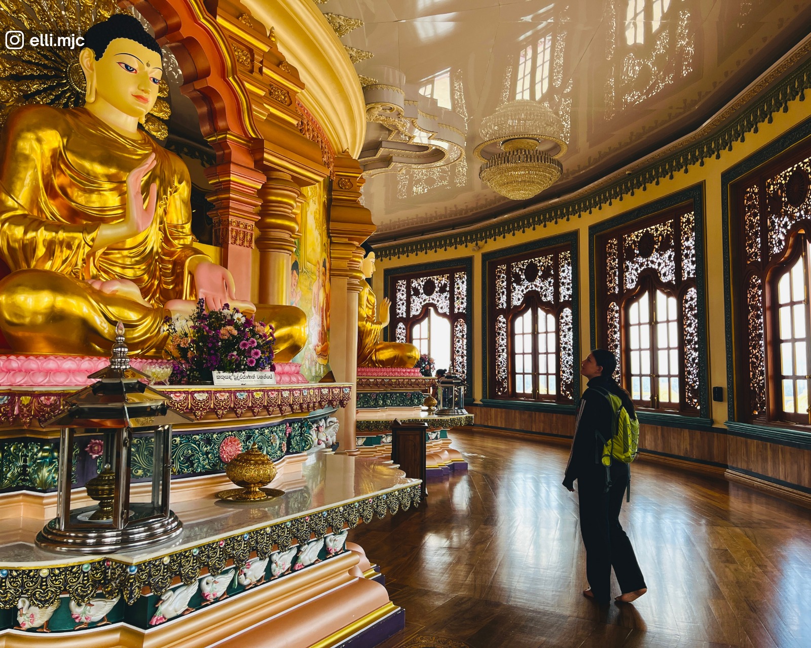 A vibrant seated Buddha statue inside the stupa of Mahamuwana Monastery in Ella showcasing Sri Lankas religious heritage