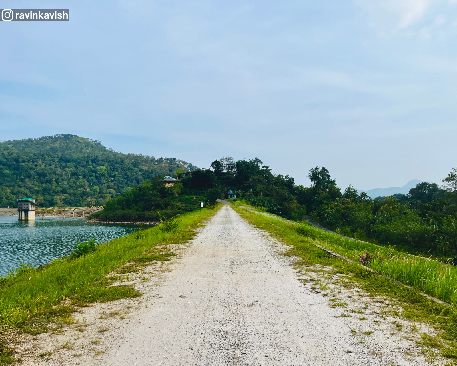 Alikota Ara Reservoir left bund in Ella with a glimpse of the water and surrounding hills showcasing Sri Lankas scenic landscapes