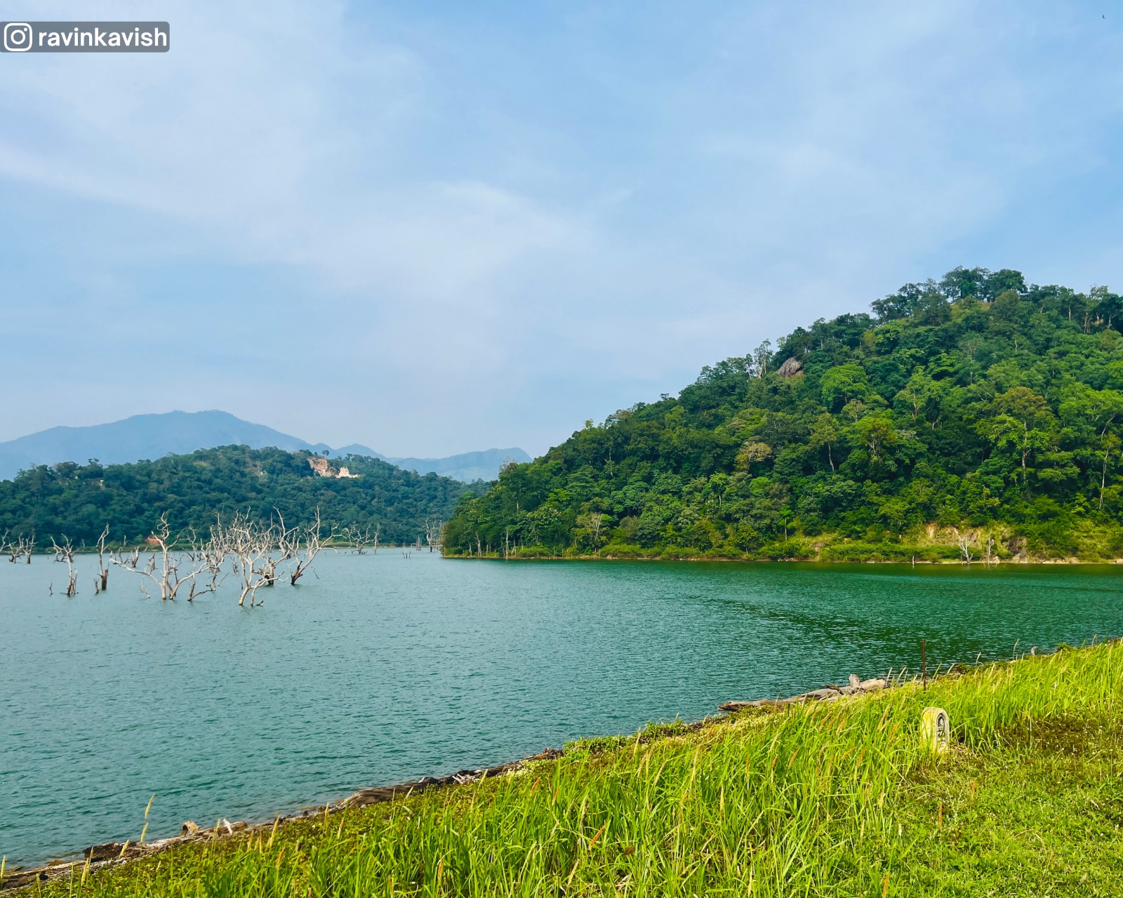 Calm waters of Alikota Ara Reservoir in Ella surrounded by hills showcasing Sri Lankas scenic landscapes