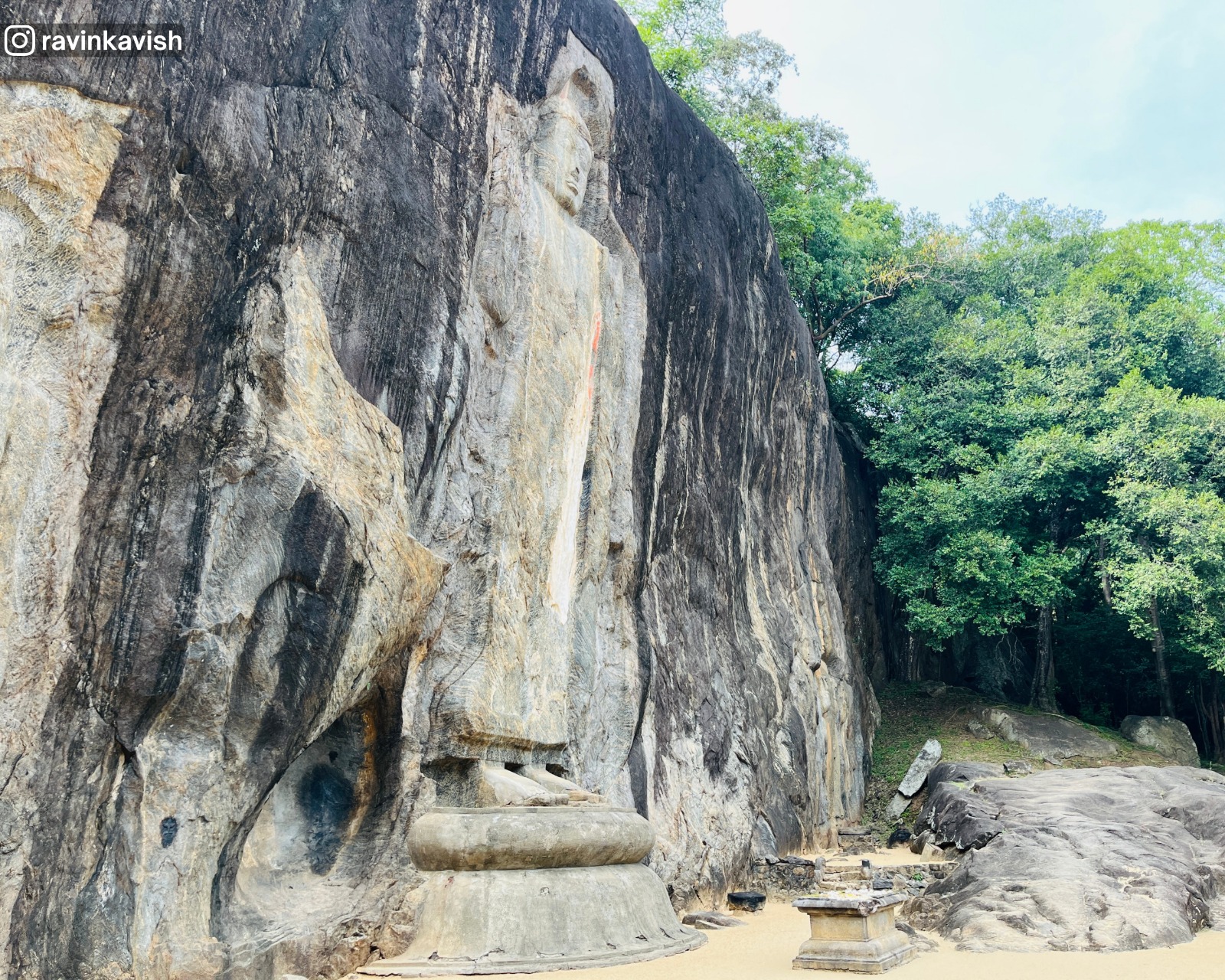 Central Buddha at Buduruwagala in Ella with the far end of the rock face visible, showcasing Sri Lankas cultural heritage