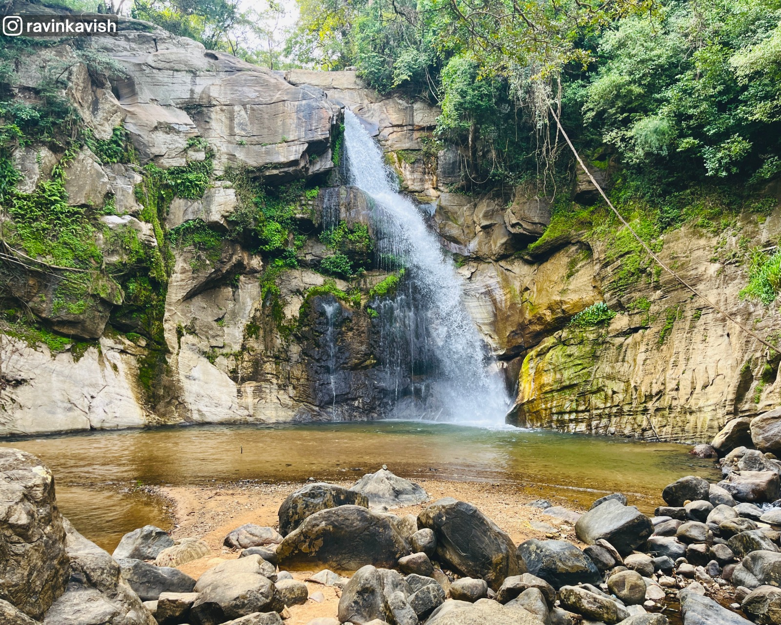 Ellewala Waterfall in Ella with surrounding rocky formations, trees, and natural scenery showcasing Sri Lankas landscapes