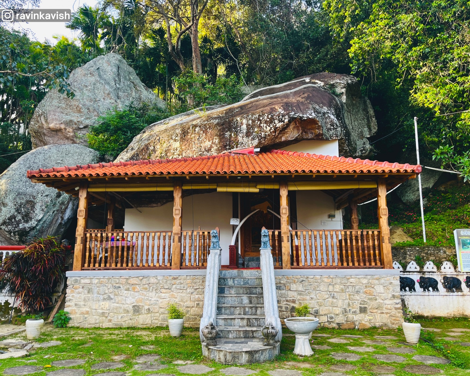 Front view of the historic image house at Ravana Royal Temple near Ella, showing the terrace garden and surrounding greenery.