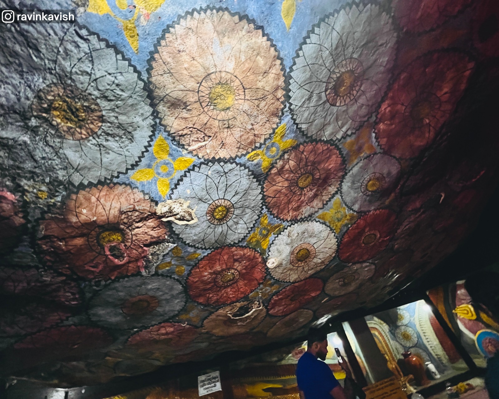 Image house at Dowa Ancient Rock Temple with a natural rock roof featuring ancient paintings.