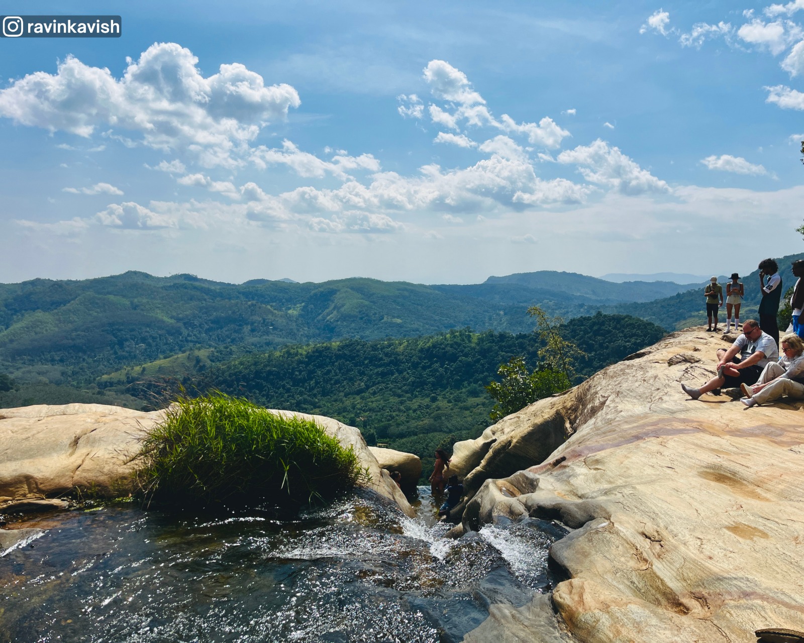 Last basin cascade feeding the final drop of Upper Diyaluma waterfall in Ella with distant mountains and lush vegetation showcasing Sri Lankas natural beauty