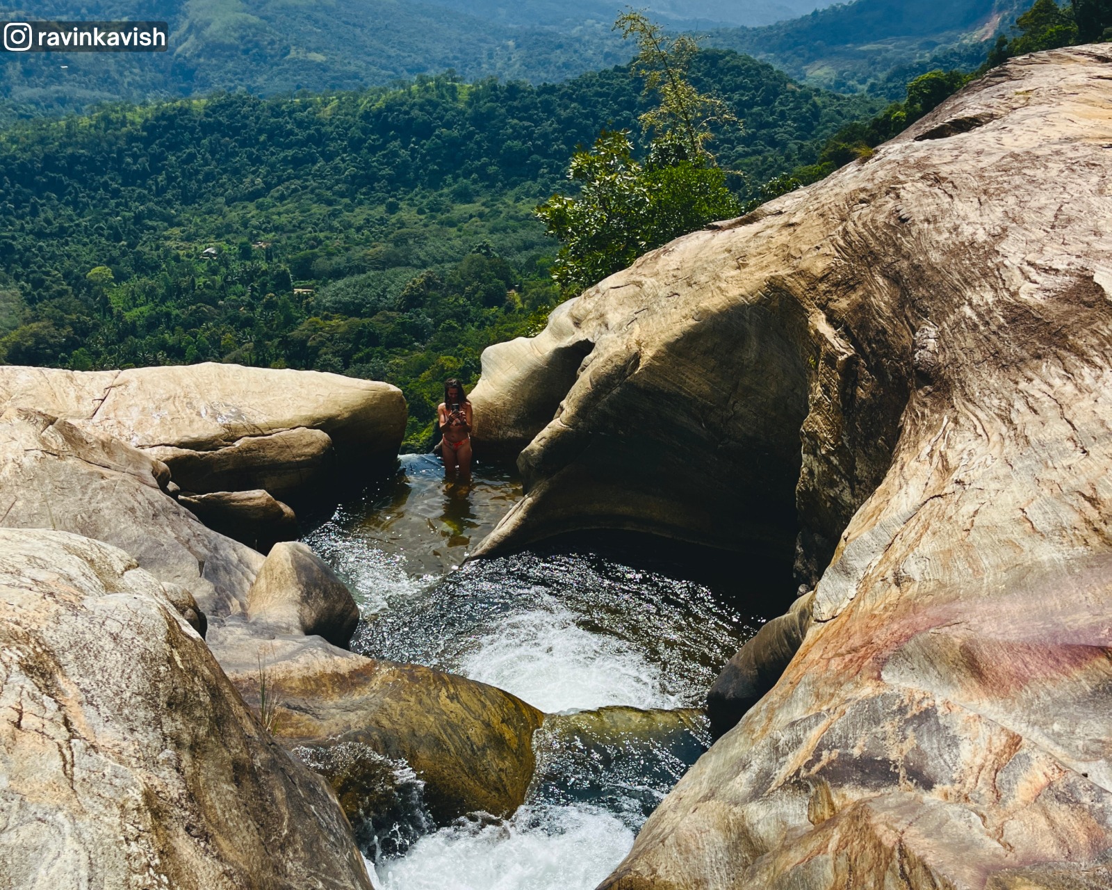 Last basin cascade feeding the final drop of Upper Diyaluma waterfall in Ella with distant mountains and lush vegetation showcasing Sri Lankas natural beauty