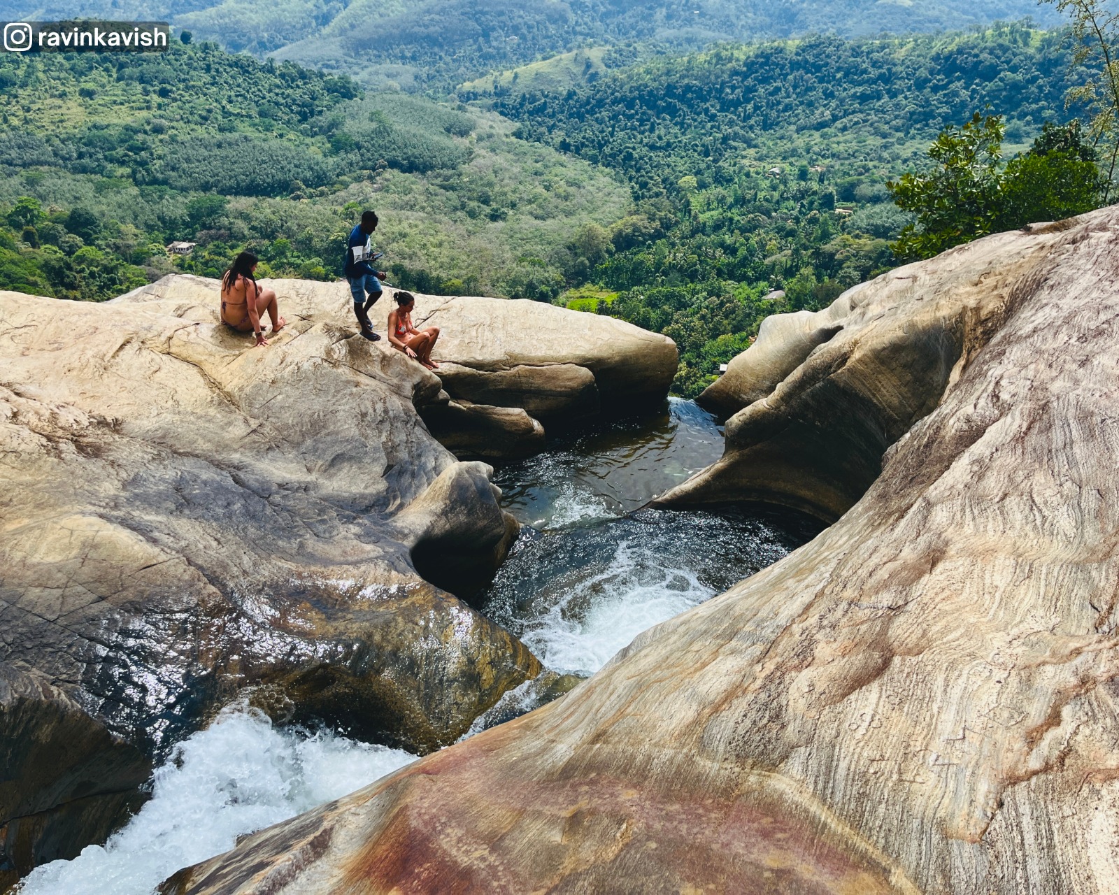 Last basin cascade feeding the final drop of Diyaluma waterfall in Ella with distant mountains and lush vegetation showcasing Sri Lankas natural beauty