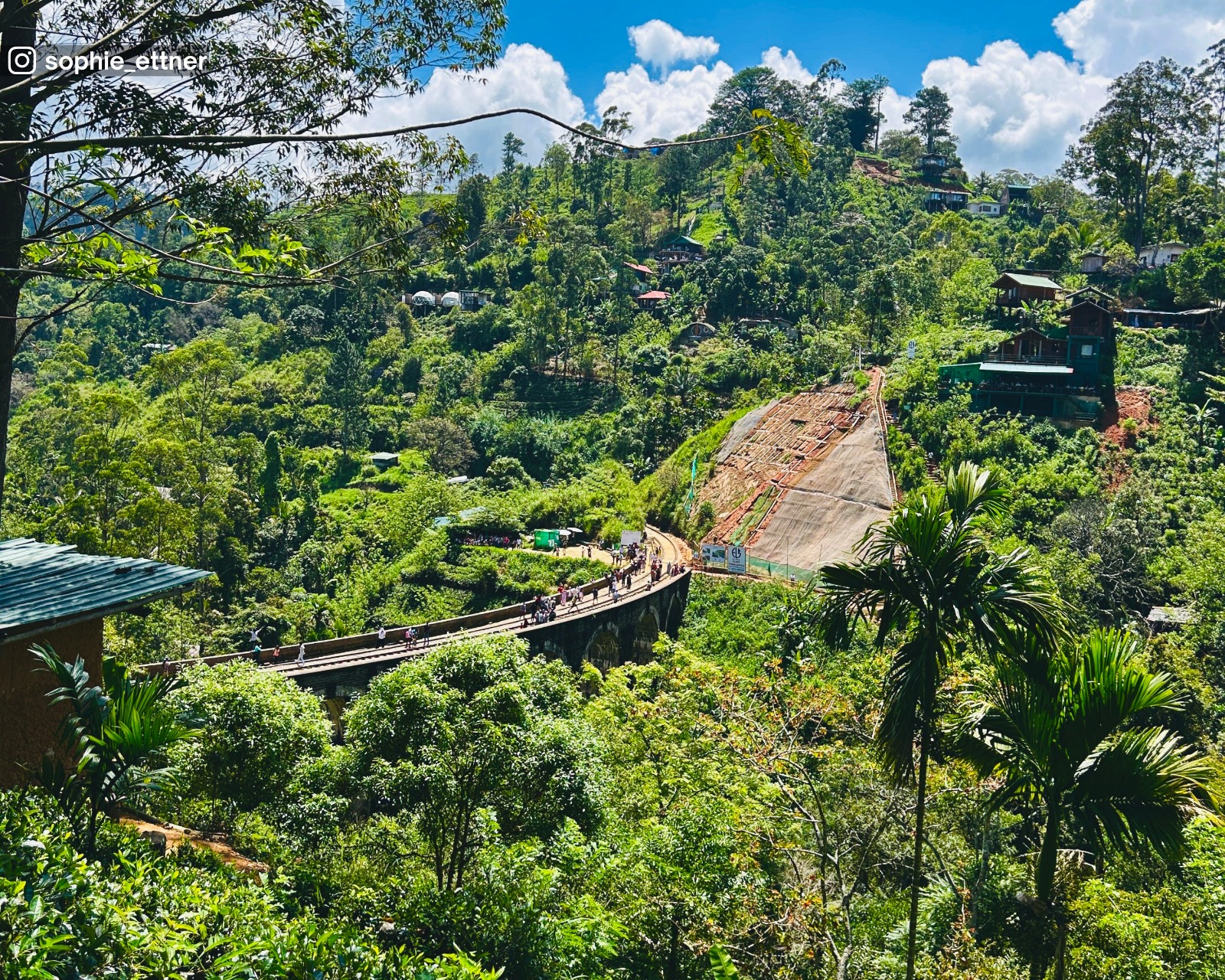 Outward curve view of the Nine Arch Bridge, highlighting its stone arches and forested surroundings