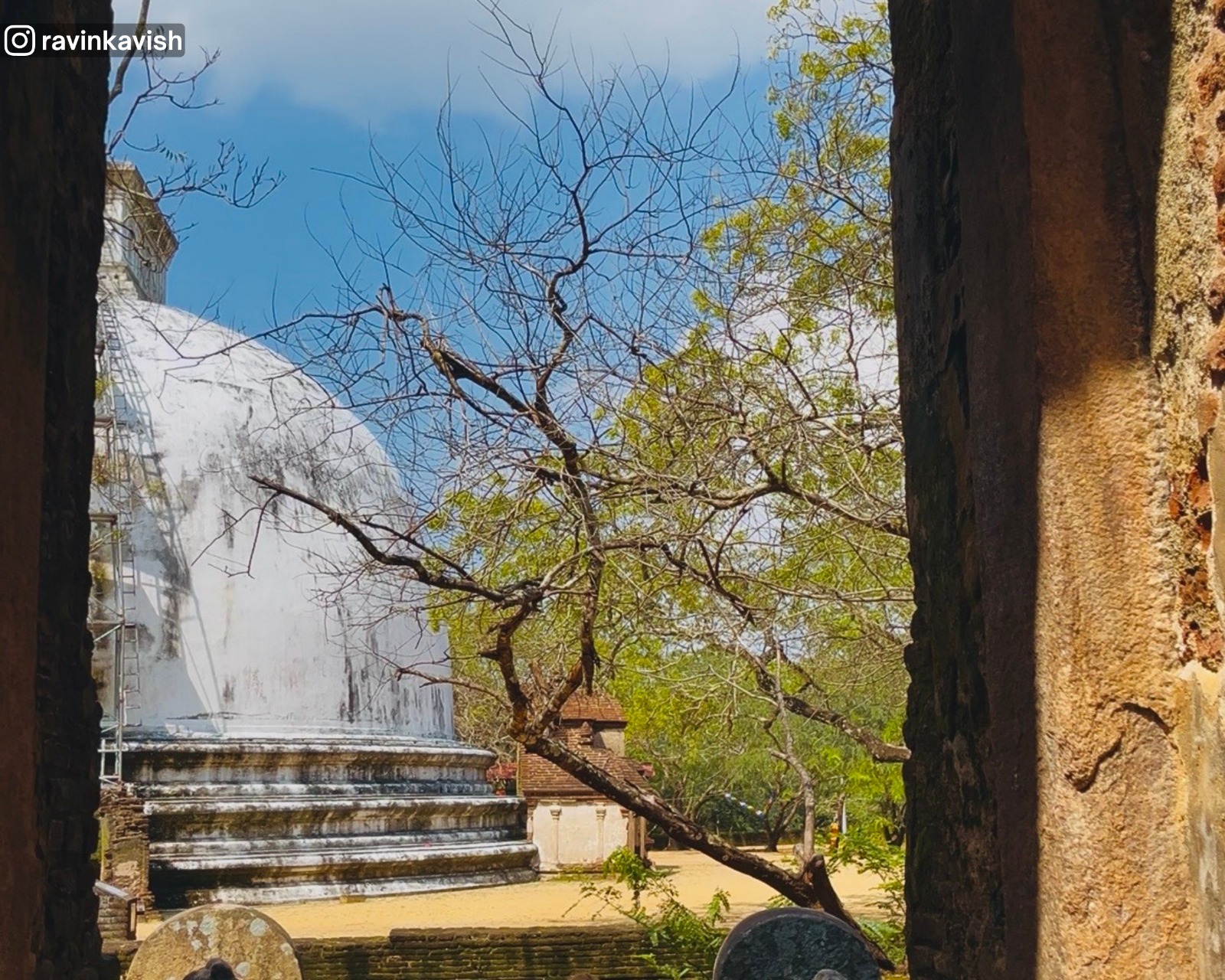 Partial view of Kiri Vehera stupa seen through an archway of Lankathilaka Temple at Alahana Monastery in Polonnaruwa