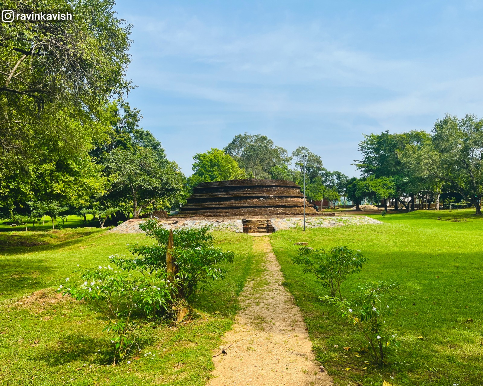 Partially ruined brick stupa (dagoba) near Buduruwagala, Sri Lanka, surrounded by greenery showcasing Sri Lankas ancient Buddhist heritage