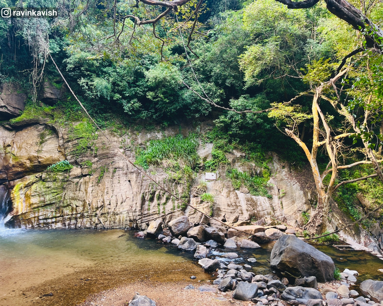 Rocky basin near Ellewala Waterfall in Ella with a natural line of rocks holding water and surrounding trees showcasing Sri Lankas natural landscapes