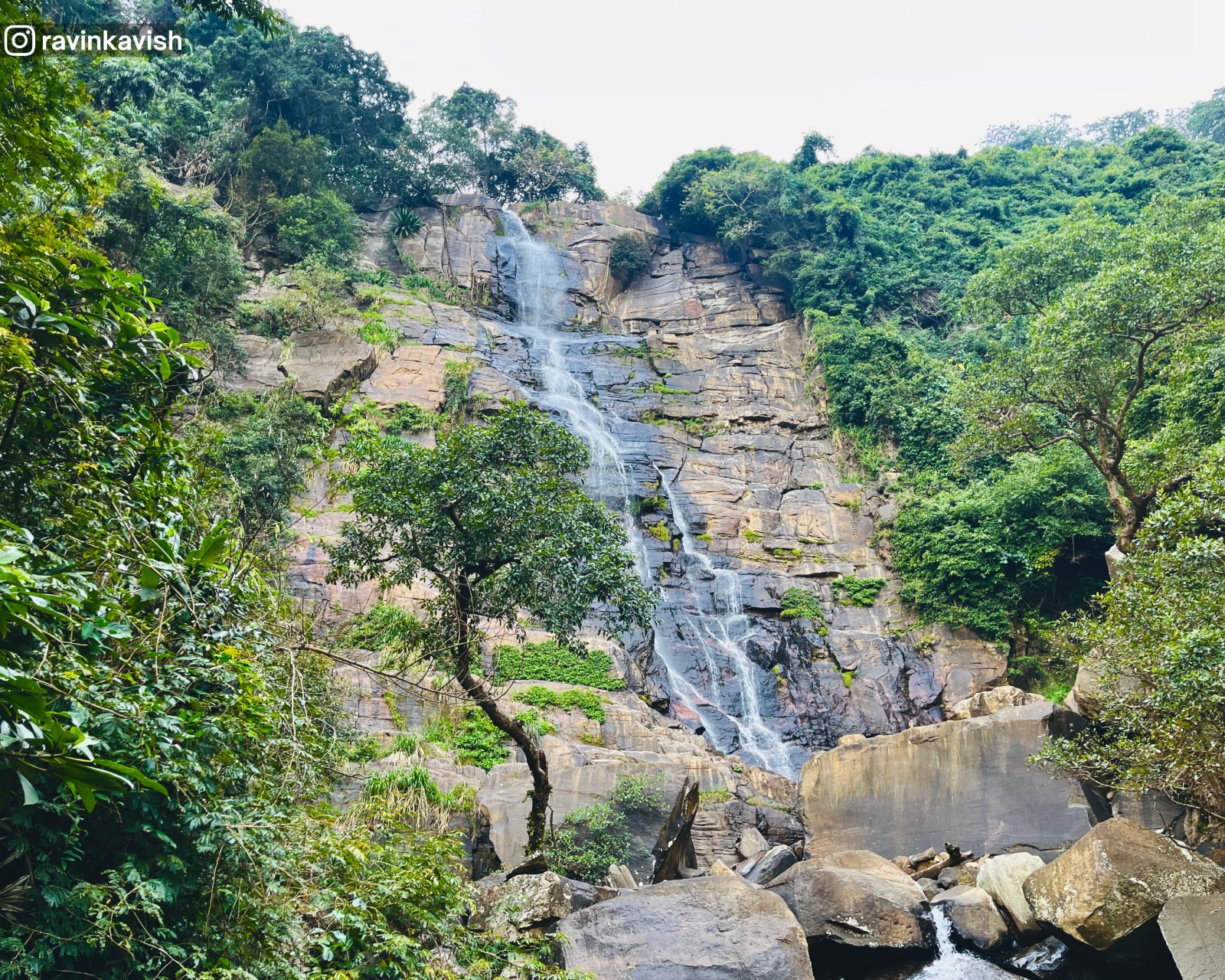 Rocky cascades of Visari Waterfall near Ella surrounded by trees and natural rock formations showcasing Sri Lankas raw landscape