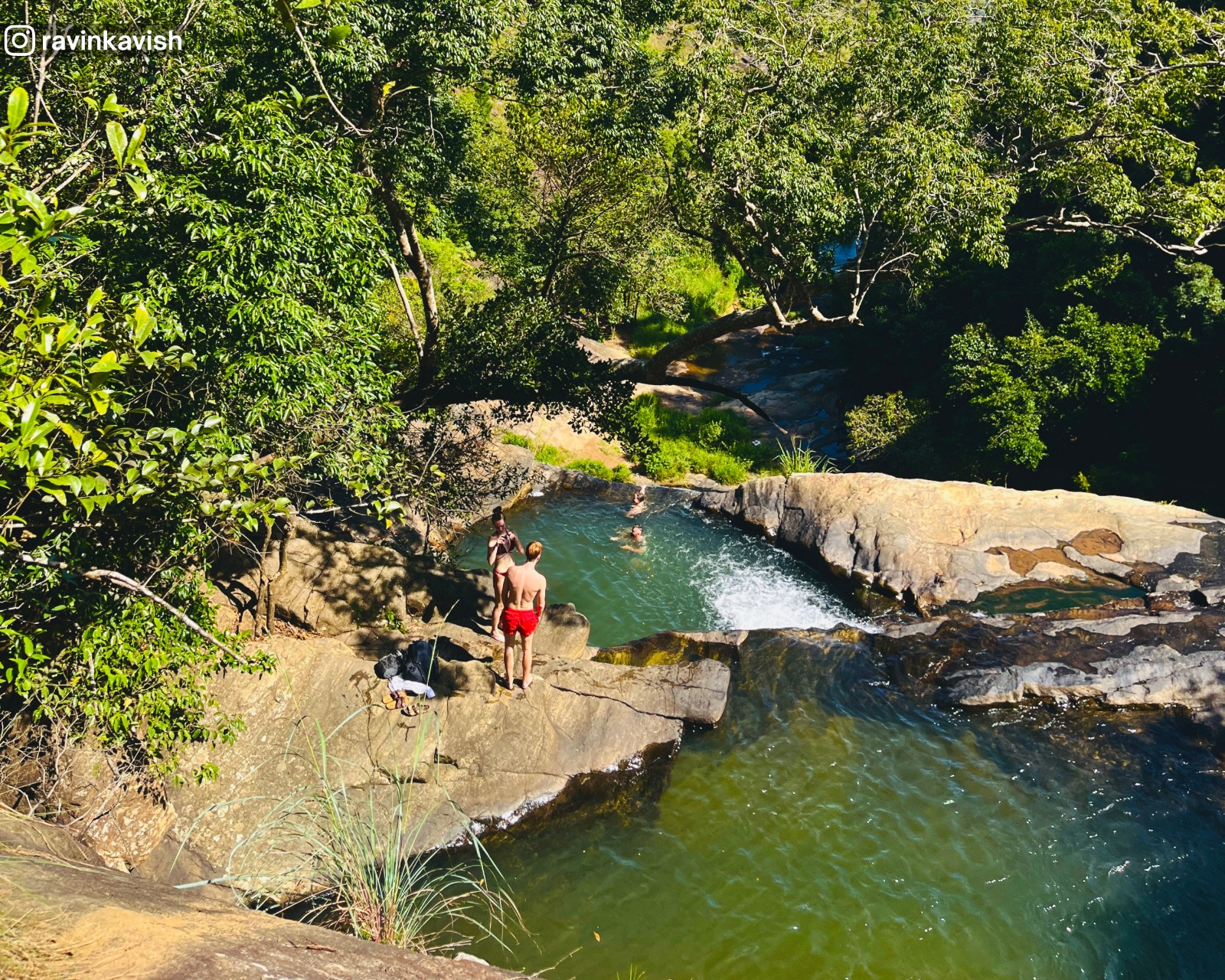 Section of Upper Diyaluma Falls showing two natural pools formed by rocks, one below the other, surrounded by lush greenery