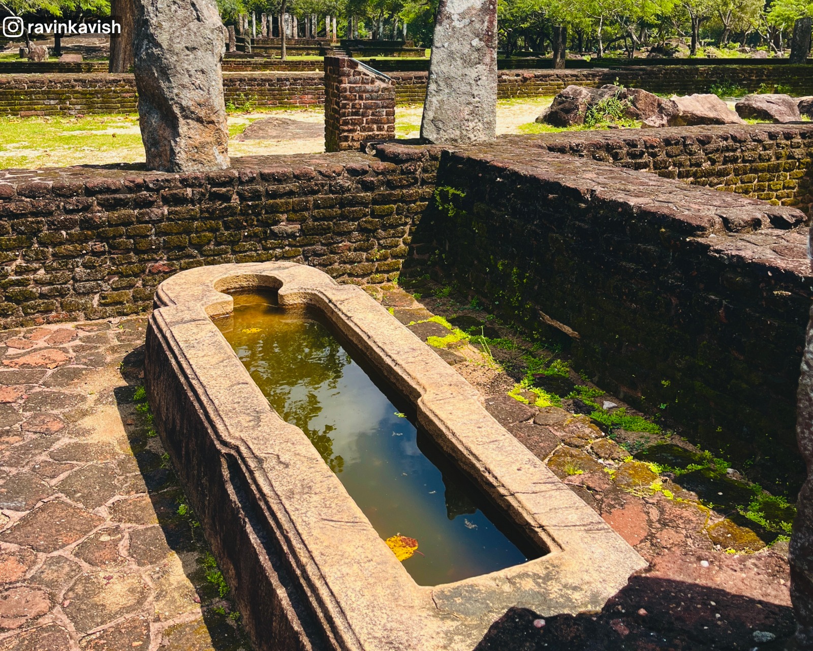 Stone medicine trough (Beheth Oruwa) with surrounding ruins of the Ancient Bhikku Hospital at Alahana Monastery in Polonnaruwa