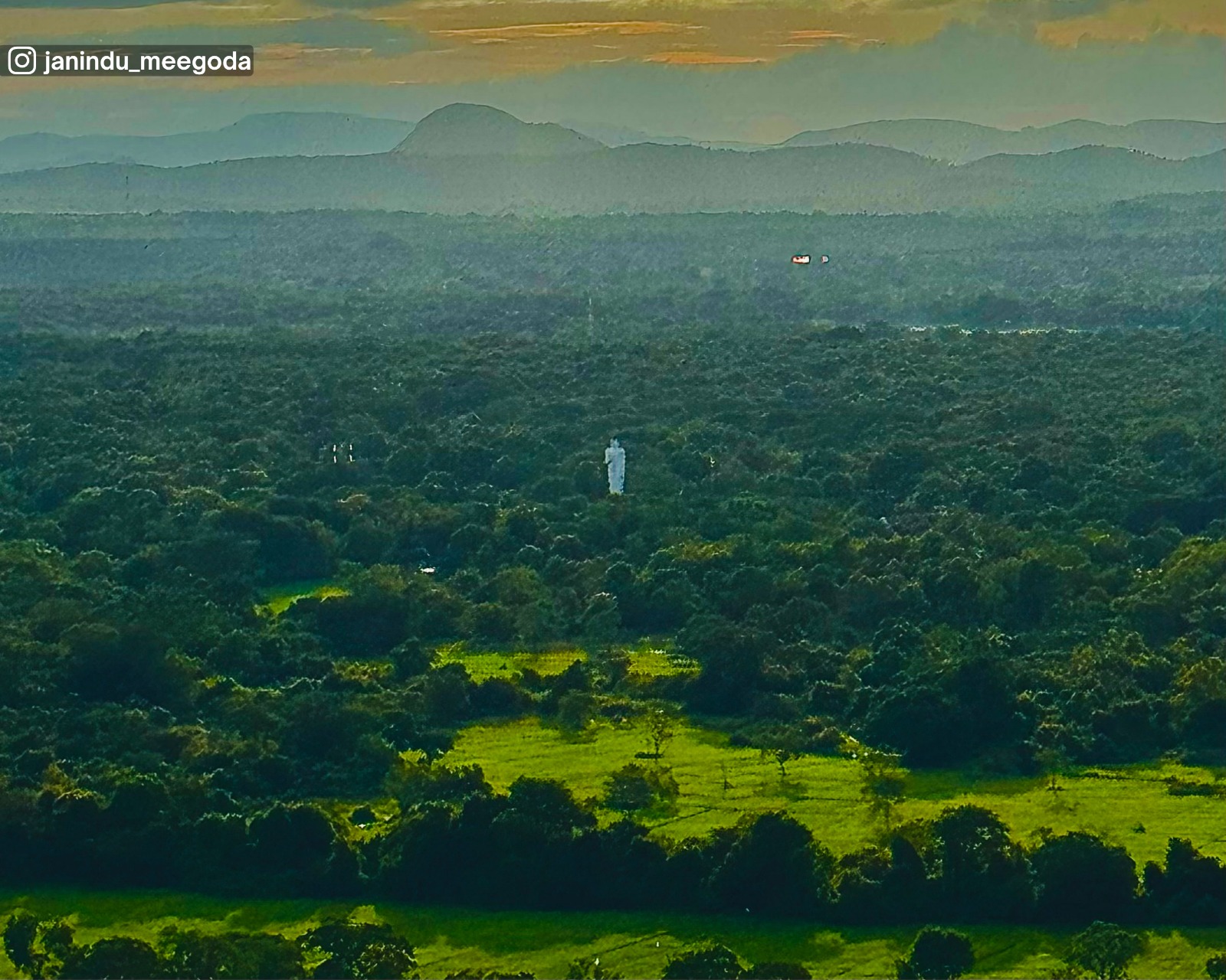 Sunset over distant plains and mountains from Pidurangala Rock