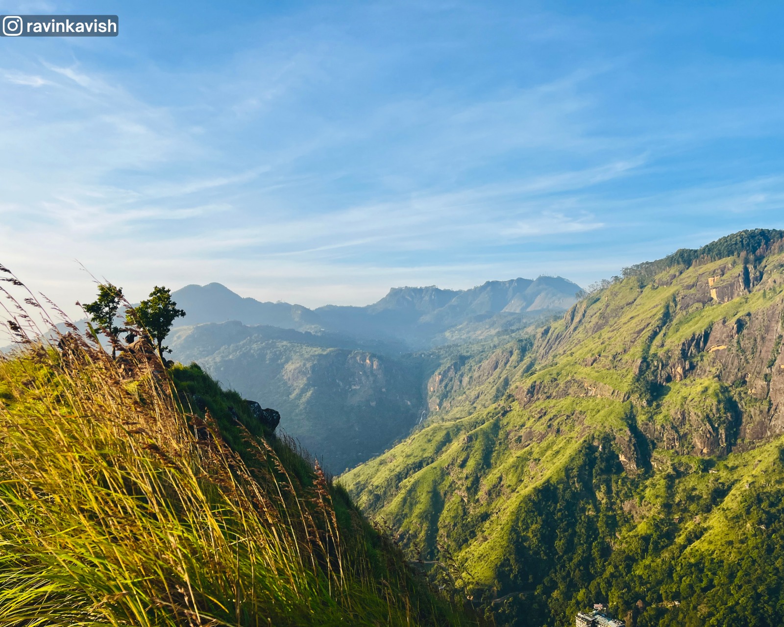 Surrounding views from the summit of Little Adams Peak in Ella with Ravana Waterfall faintly visible showcasing Sri Lankas scenic hill country