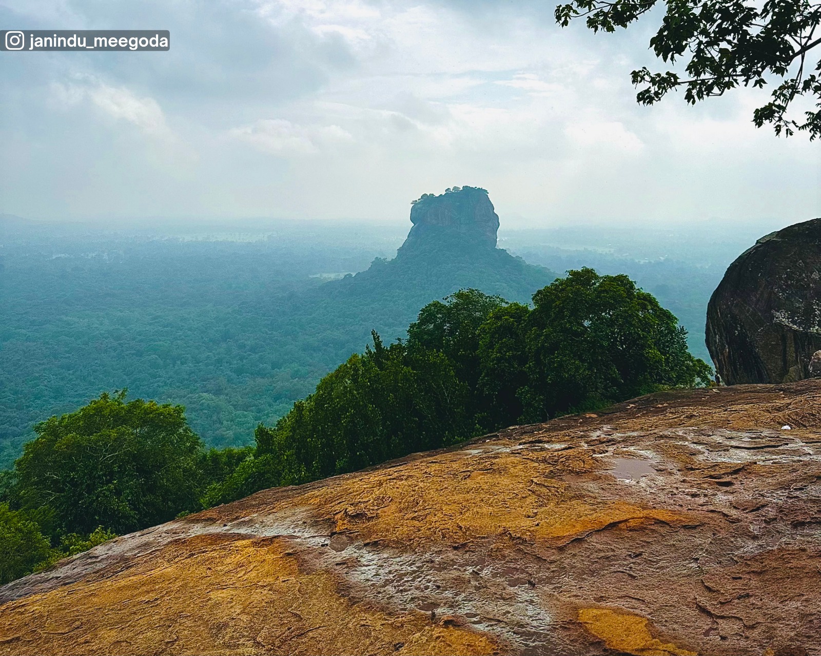 View of Sigiriya Rock rising from Pidurangala Rock on a rainy day