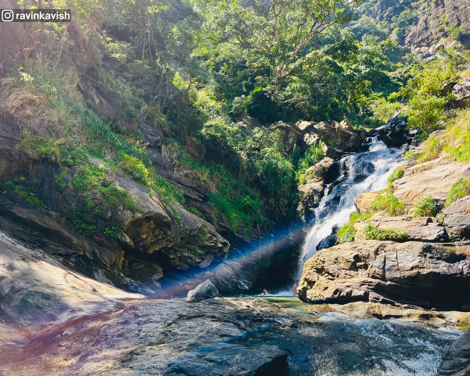 Visitors enjoying a dip at the basin of Ravana Waterfall in Ella showcasing Sri Lankas natural beauty and recreational spots