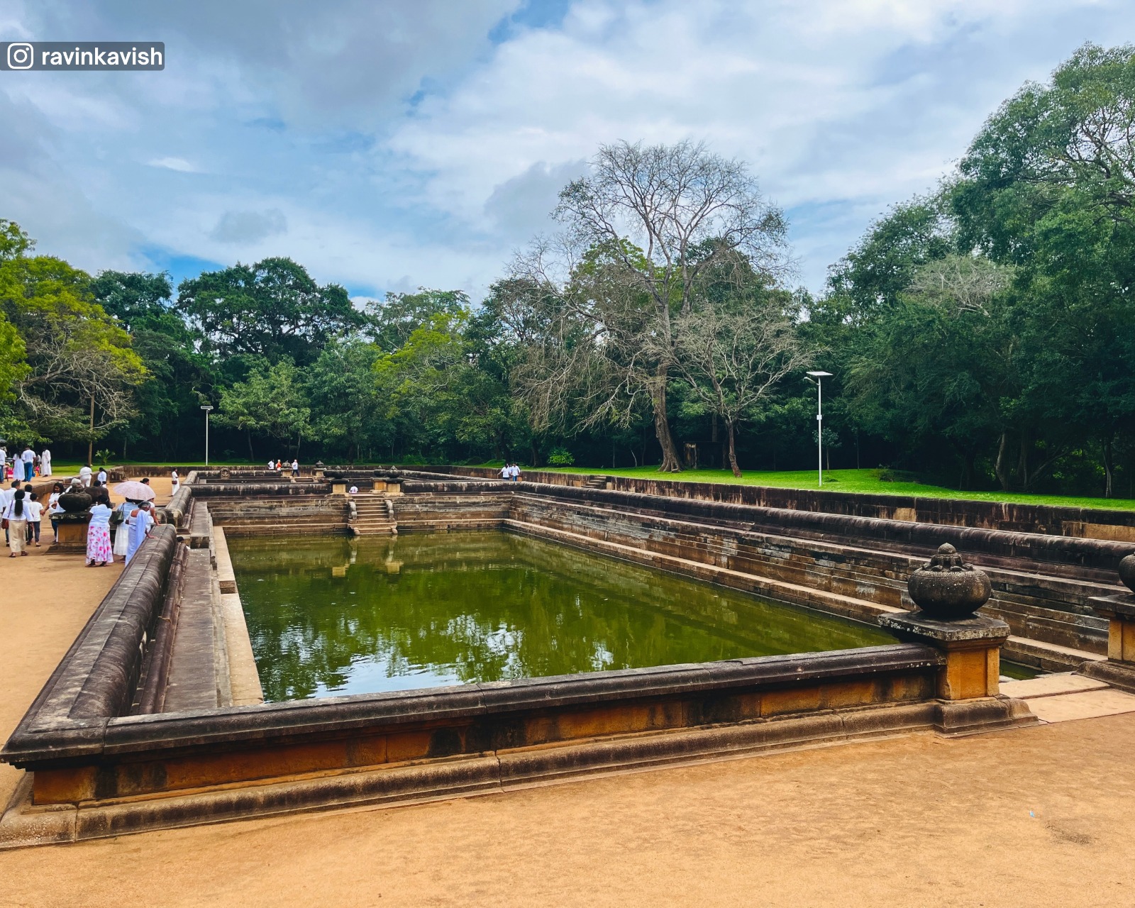 Stone steps and clear water of the ancient Kuttam Pokuna Twin Ponds in Anuradhapura