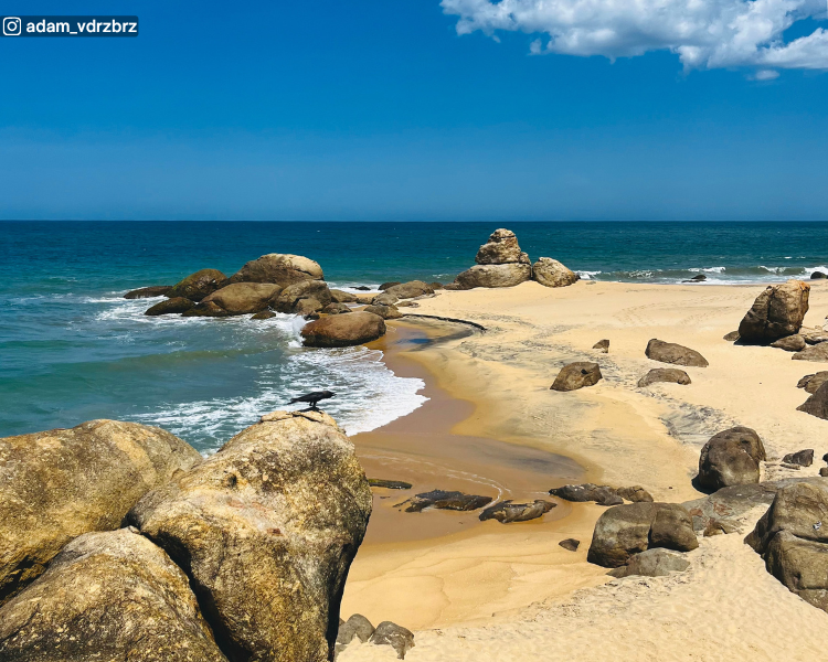 Rocky shoreline with sea, sky and horizon at Pottuvil Point near Arugam Bay, Sri Lanka