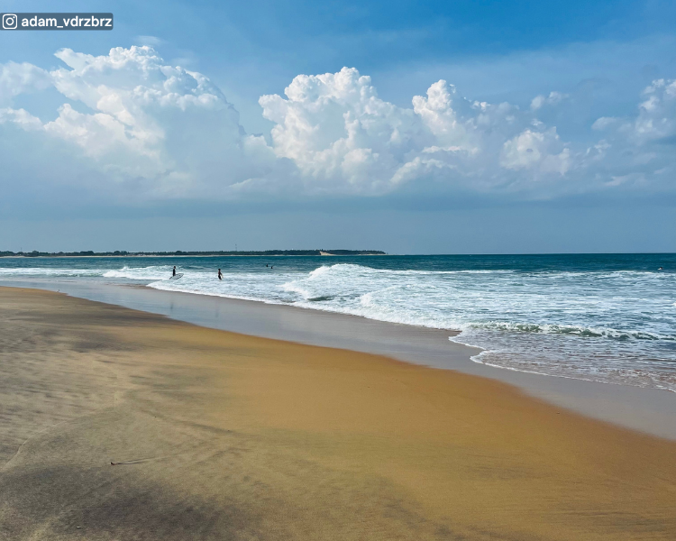Shoreline, sea and distant tree line at Pasarichenai Beach near Arugam Bay on Sri Lanka’s east coast