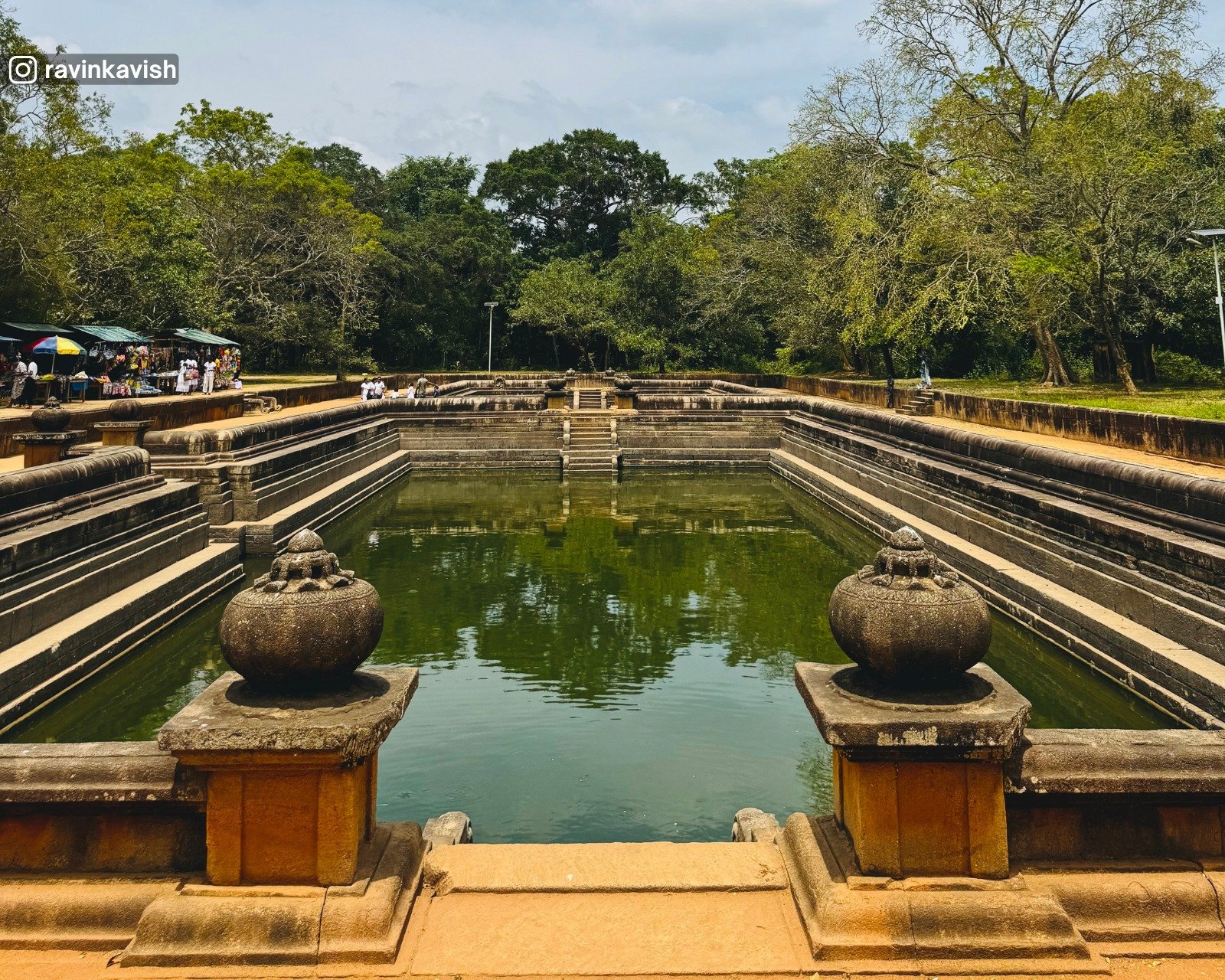 Stone steps and clear water of the ancient Kuttam Pokuna Twin Ponds in Anuradhapura