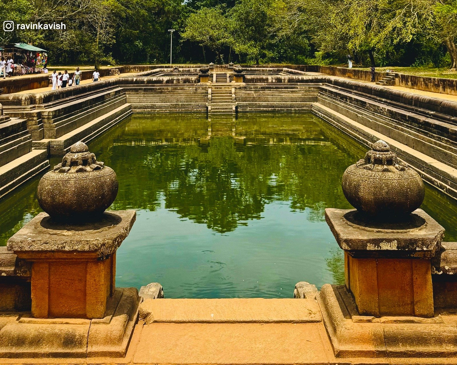 Stone steps and clear water of the ancient Kuttam Pokuna Twin Ponds in Anuradhapura