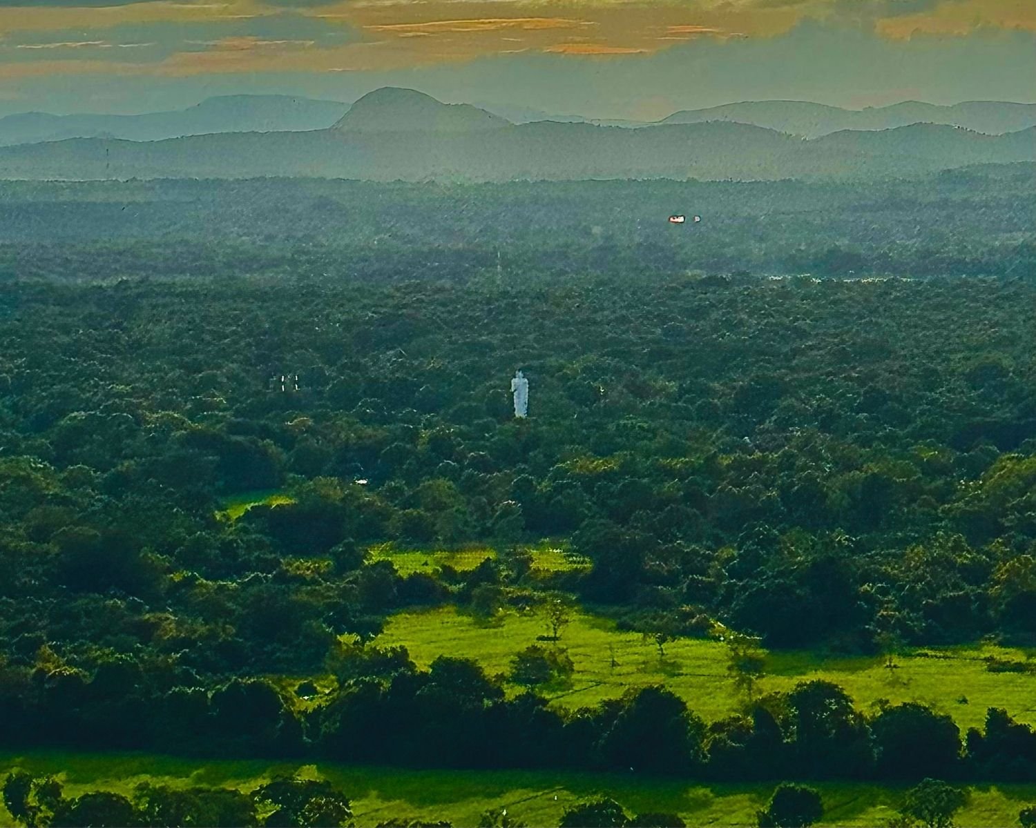 White standing Buddha statue at Sigiriya temple rising from dense jungle with bright green rice paddy fields and layered blue mountains at sunrise, distant view from Pidurangala Rock summit near Sigiriya