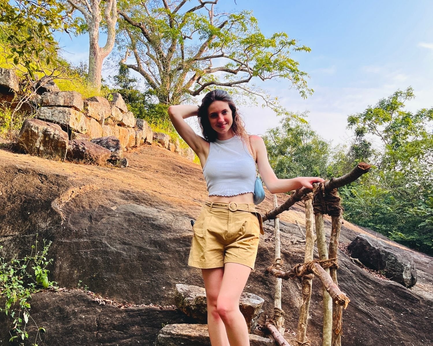 Stone steps with wooden handrail and ancient stone wall on trail to mid-tier summit at Mapagala Fortress Little Pidurangala Sri Lanka