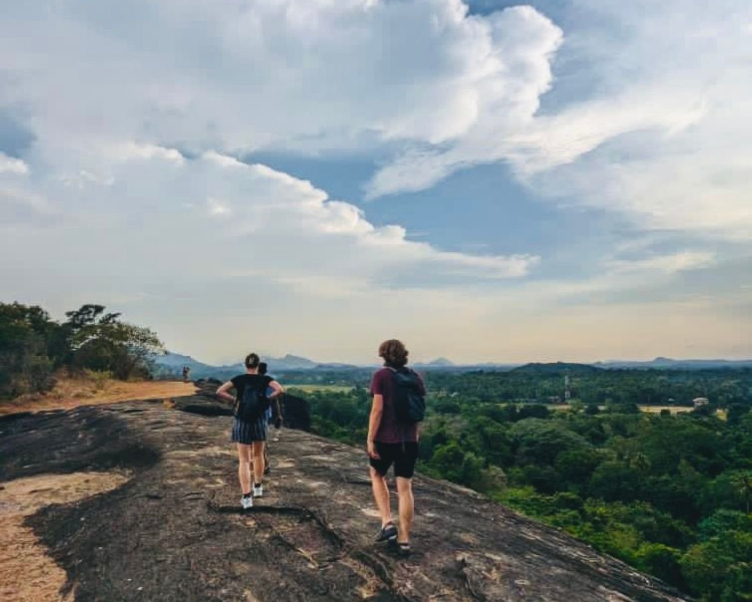 Expansive rock summit plateau with panoramic views over grassy plains at Mapagala Fortress Little Pidurangala Sri Lanka