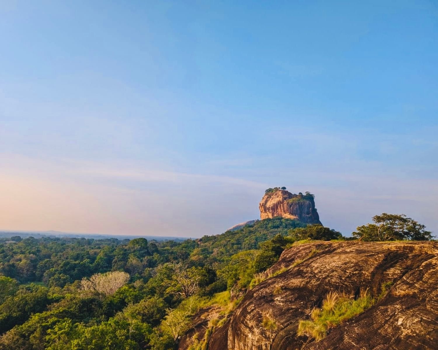 Golden hour view of Sigiriya Lion Rock from summit rock outcrop at Mapagala Fortress Little Pidurangala Sri Lanka