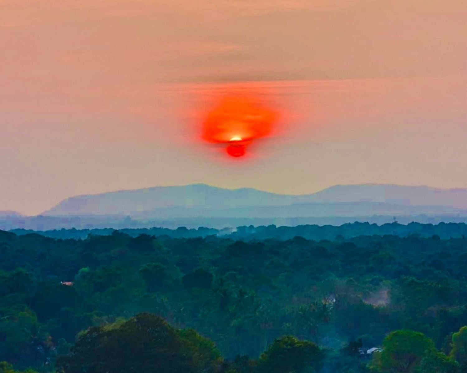 Sunset panorama over jungle plains and distant hills from summit at Mapagala Fortress Little Pidurangala Sri Lanka