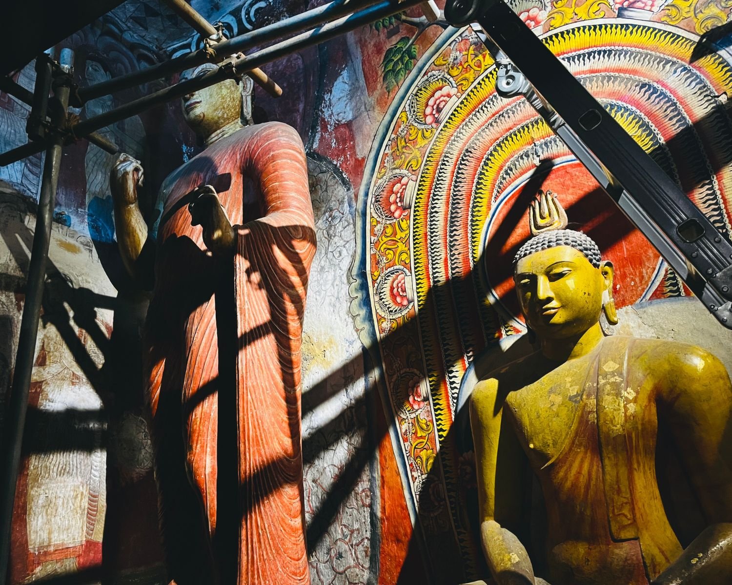 Standing and seated Buddha statues inside Devaraja Cave