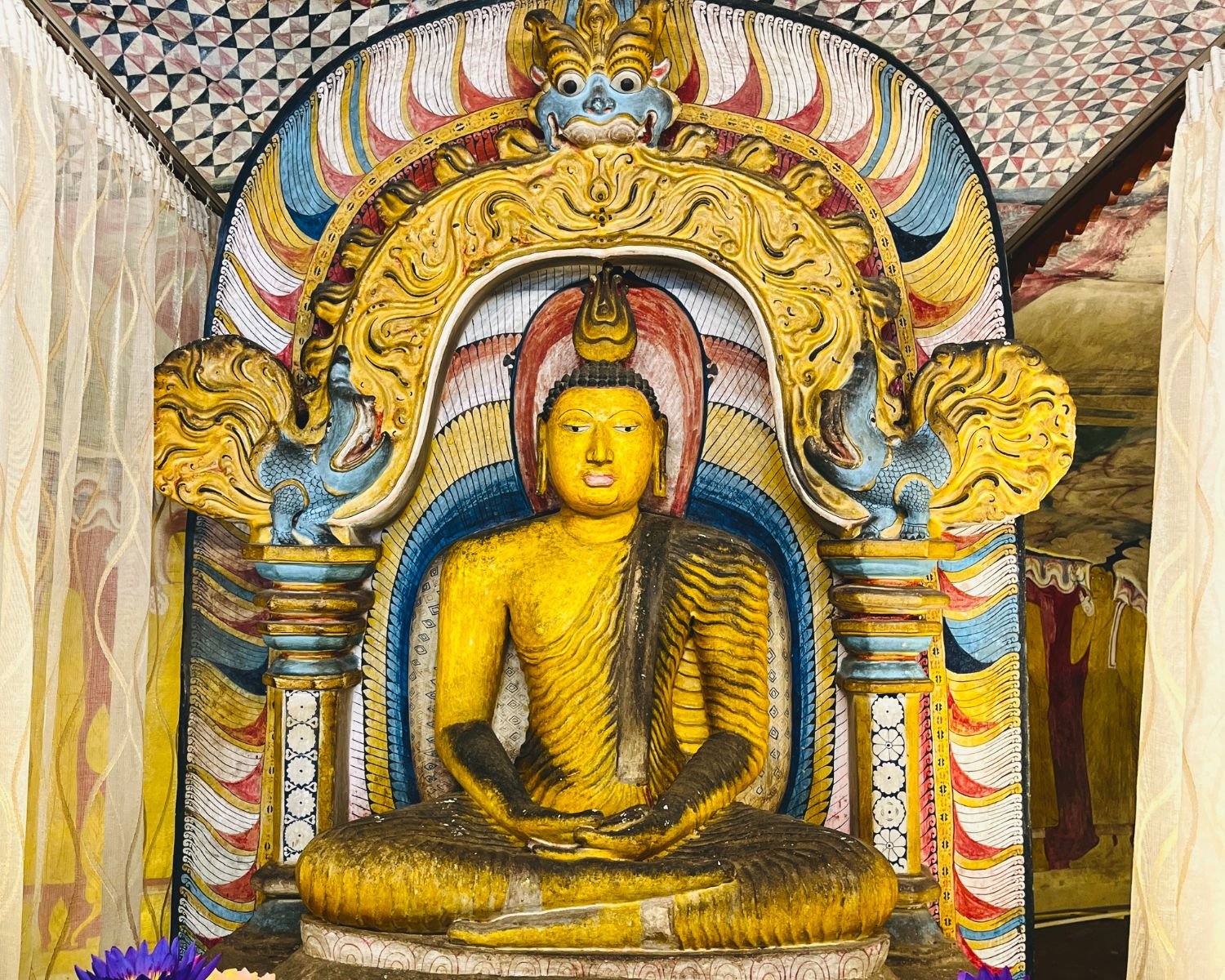 Seated Buddha beneath a decorated Makara Torana
