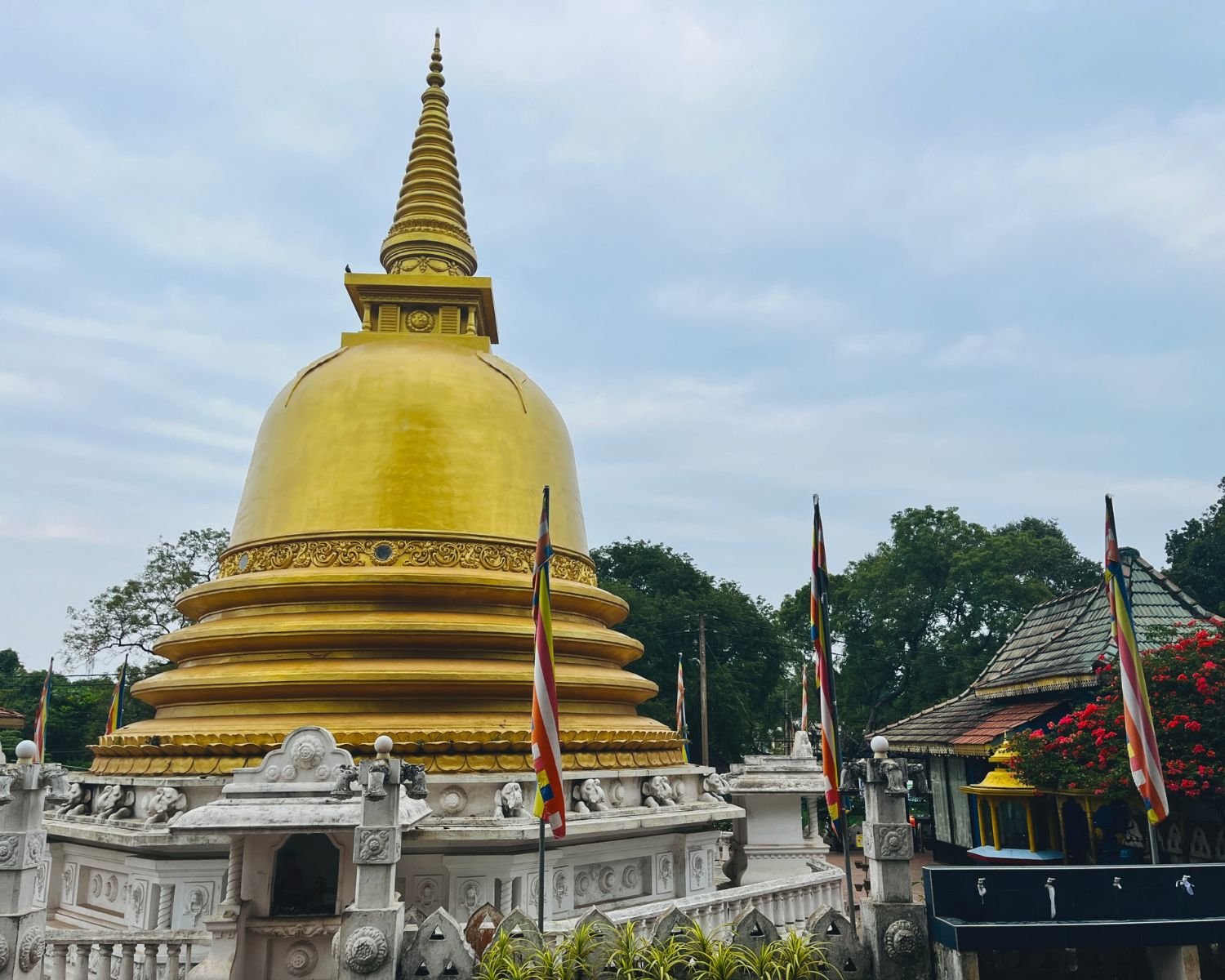 Close view of a golden stupa with Buddhist flags