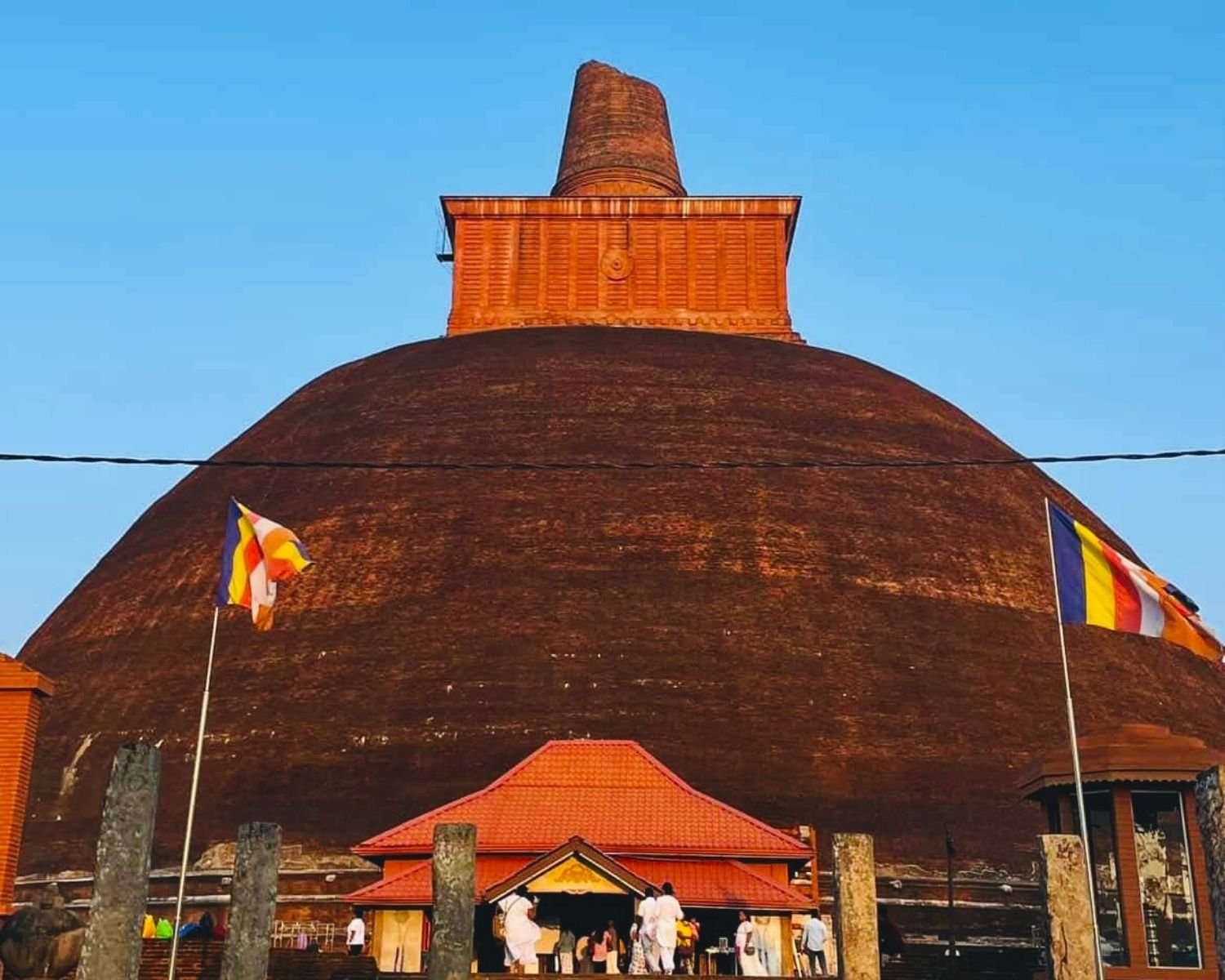Jetavanaramaya brick stupa west entrance close view with broken spire and ancient stone pillars