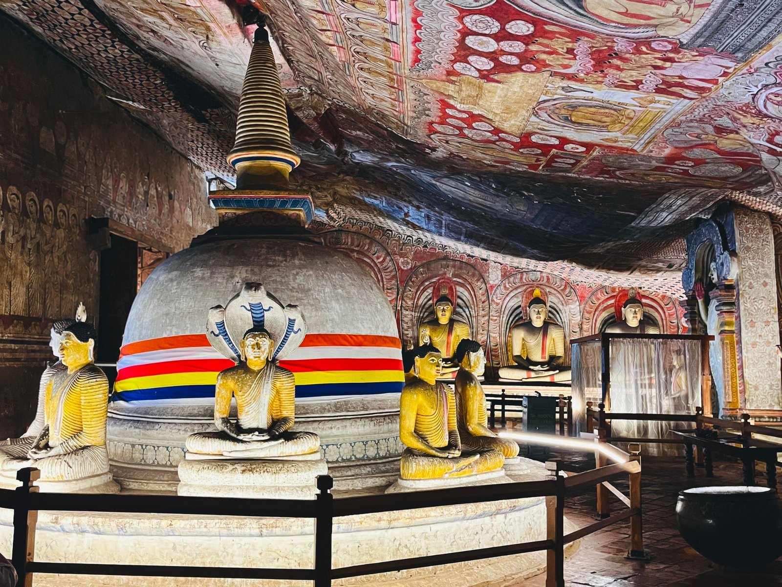 Sacred cave stupa encircled by seated Buddha statues