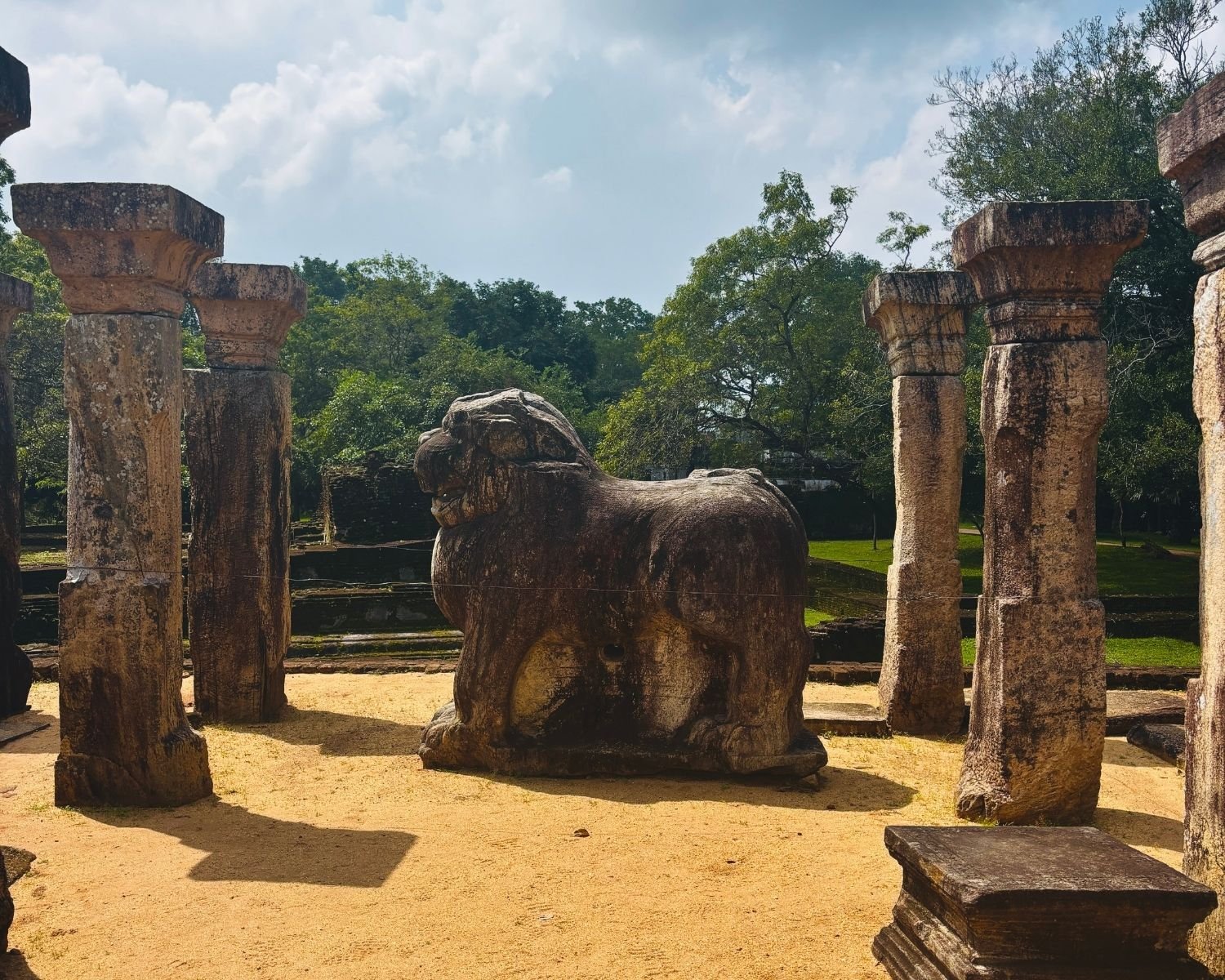 Council Chamber of Nissanka Malla showing carved stone lion statue between weathered stone pillars