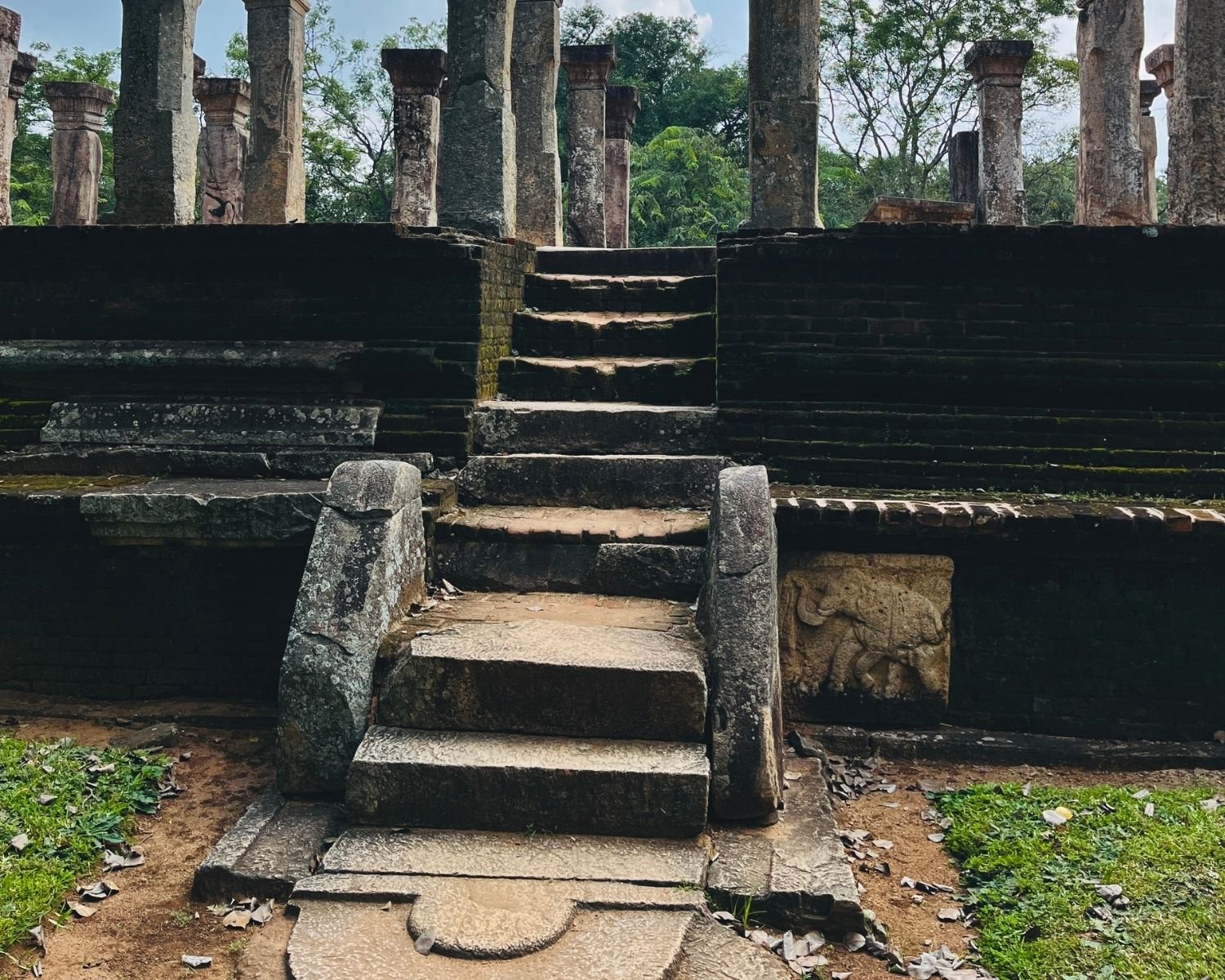 Council Chamber of Nissanka Malla side stairway with moonstone, elephant relief panel, and standing pillars