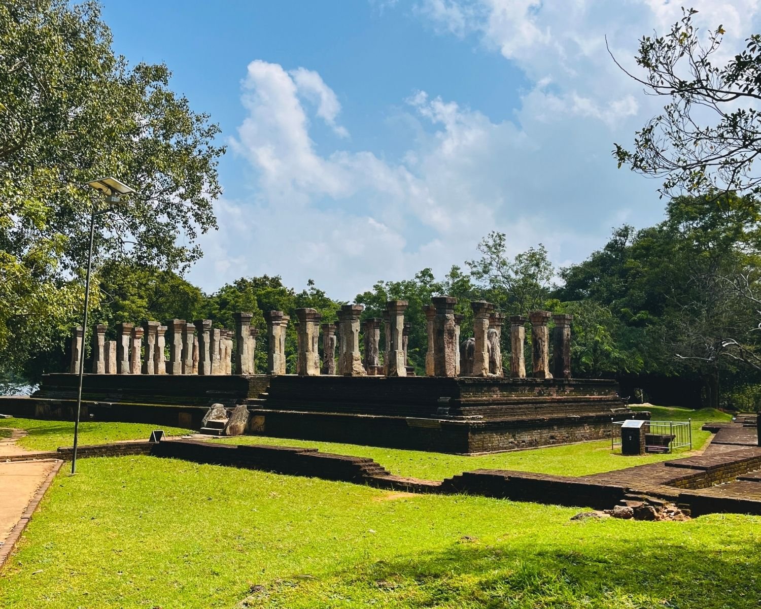 Wide view of Council Chamber of Nissanka Malla showing raised stone platform and rows of pillars