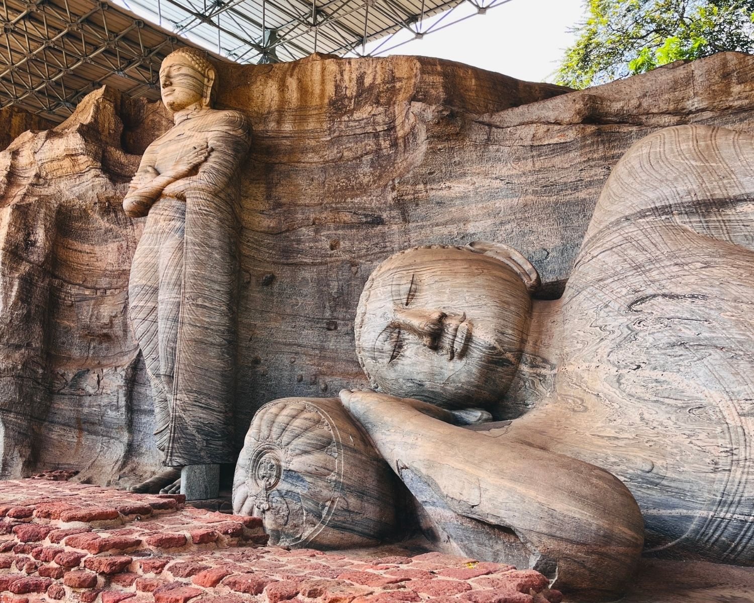 Reclining Parinirvana Buddha face detail with standing Buddha beside it at Gal Vihara
