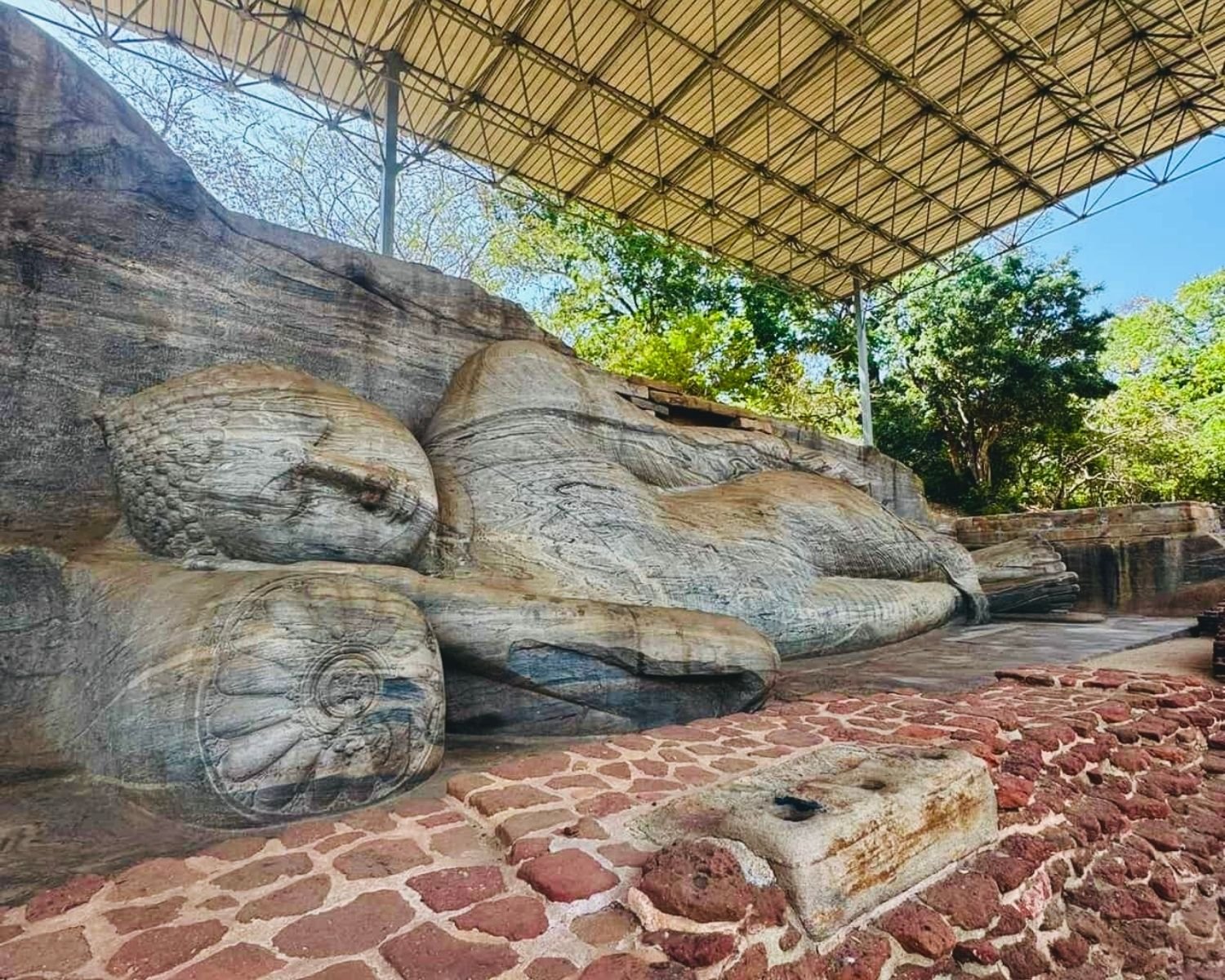 Low side view of reclining Parinirvana Buddha carved in granite at Gal Vihara Uttararama
