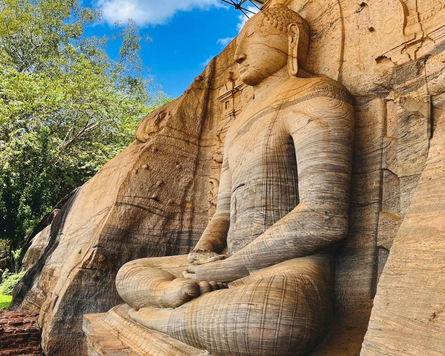 Close side view of seated Dhyana Buddha with robe lines at Gal Vihara Uttararama