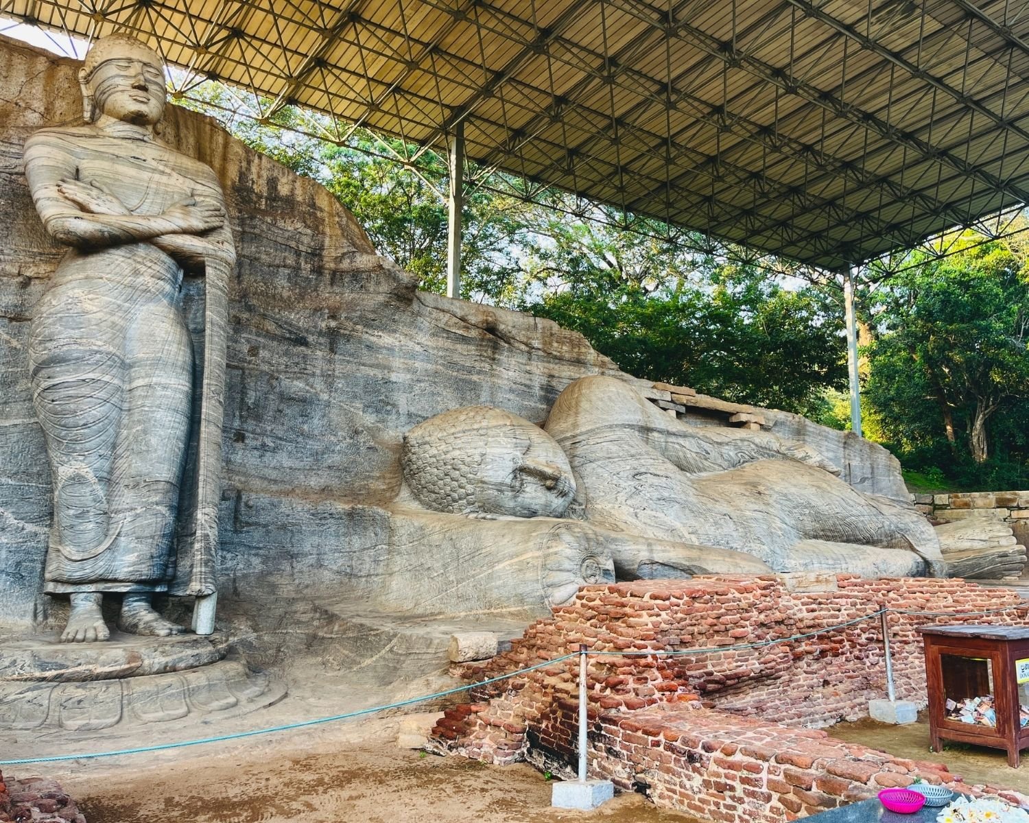 Standing Buddha beside reclining Parinirvana Buddha at Gal Vihara Uttararama with brick ruins