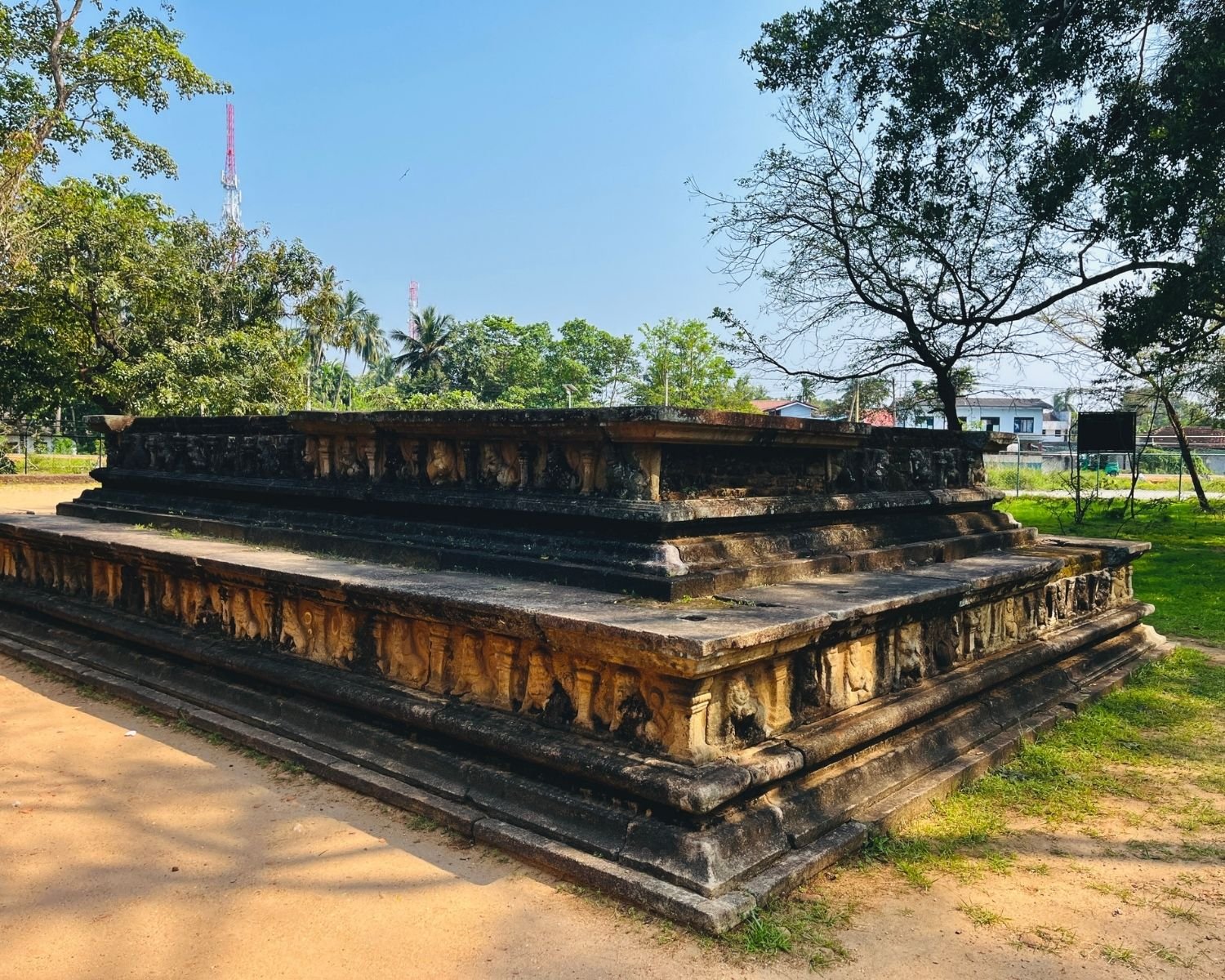 Raised stone platform beside Kumara Pokuna showing carved stone bands and stepped levels
