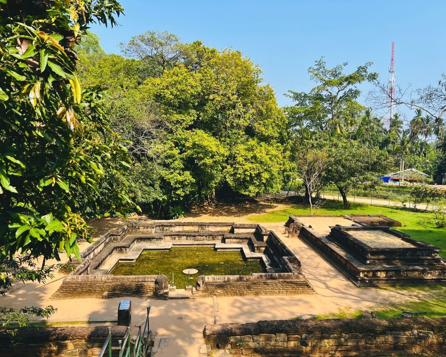 Wide view of Kumara Pokuna Prince's Pond showing royal bathing pond and adjacent raised stone platform