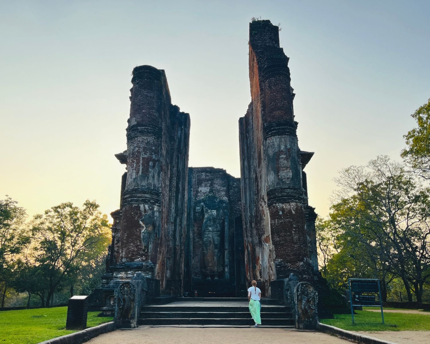 17m brick pilasters and remains of giant standing Buddha at Lankatilaka Image House with sunset sky