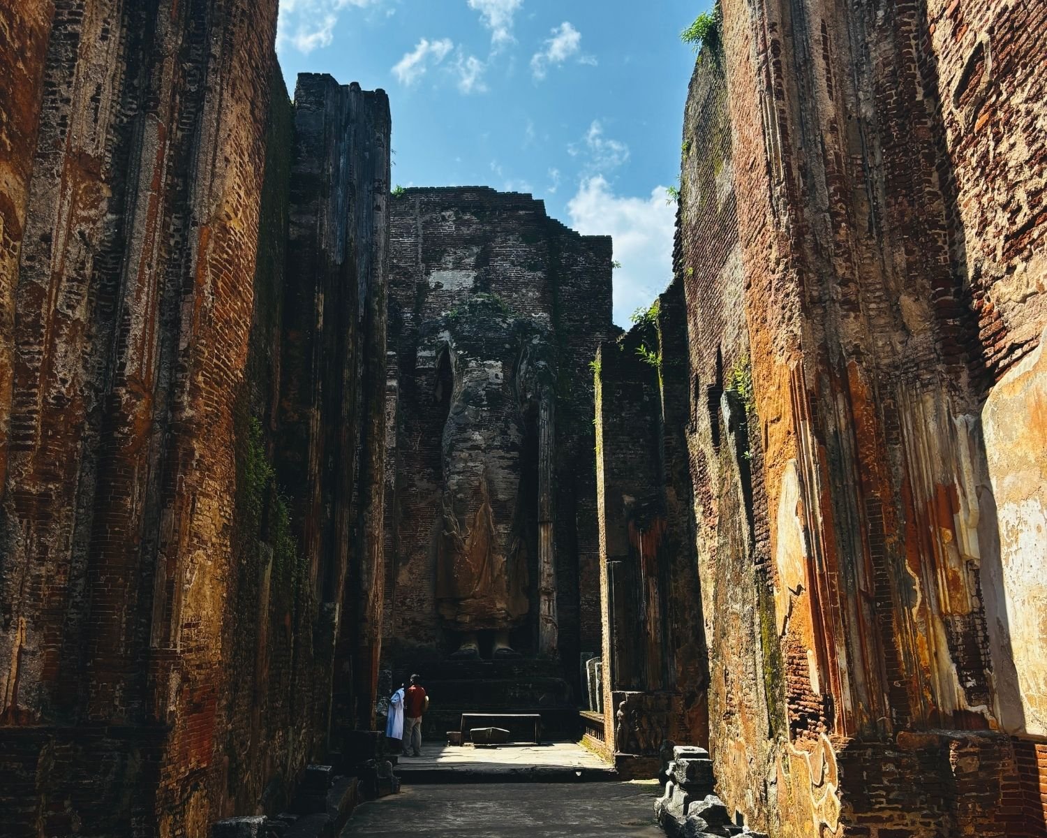 Interior of Lankatilaka showing 14m headless standing Buddha between tall brick walls with open sky above